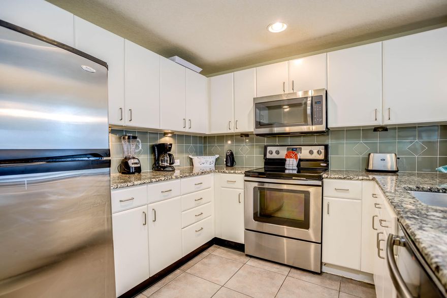 **RECUDED** East Corner Condo at Grand Panama Beach Resort well positioned on the 13th floor offering impeccable views from all bedrooms, living/kitchen areas and the expansive balcony allowing for ample seating. As you enter the property you'll find 2 guest rooms near the entryway each with queen beds. They share a nice sized guest bath with tile shower along with the recessed bunk area in the hallway. The condo features tile floors throughout, stainless appliances, granite countertops and is sold turn-key for the rental season ahead. The kitchen is open to the dining area with a large window offering additional views to the east on the side of the building. The living room and master bedroom both offer balcony access and balcony itself affords for plenty of seating.