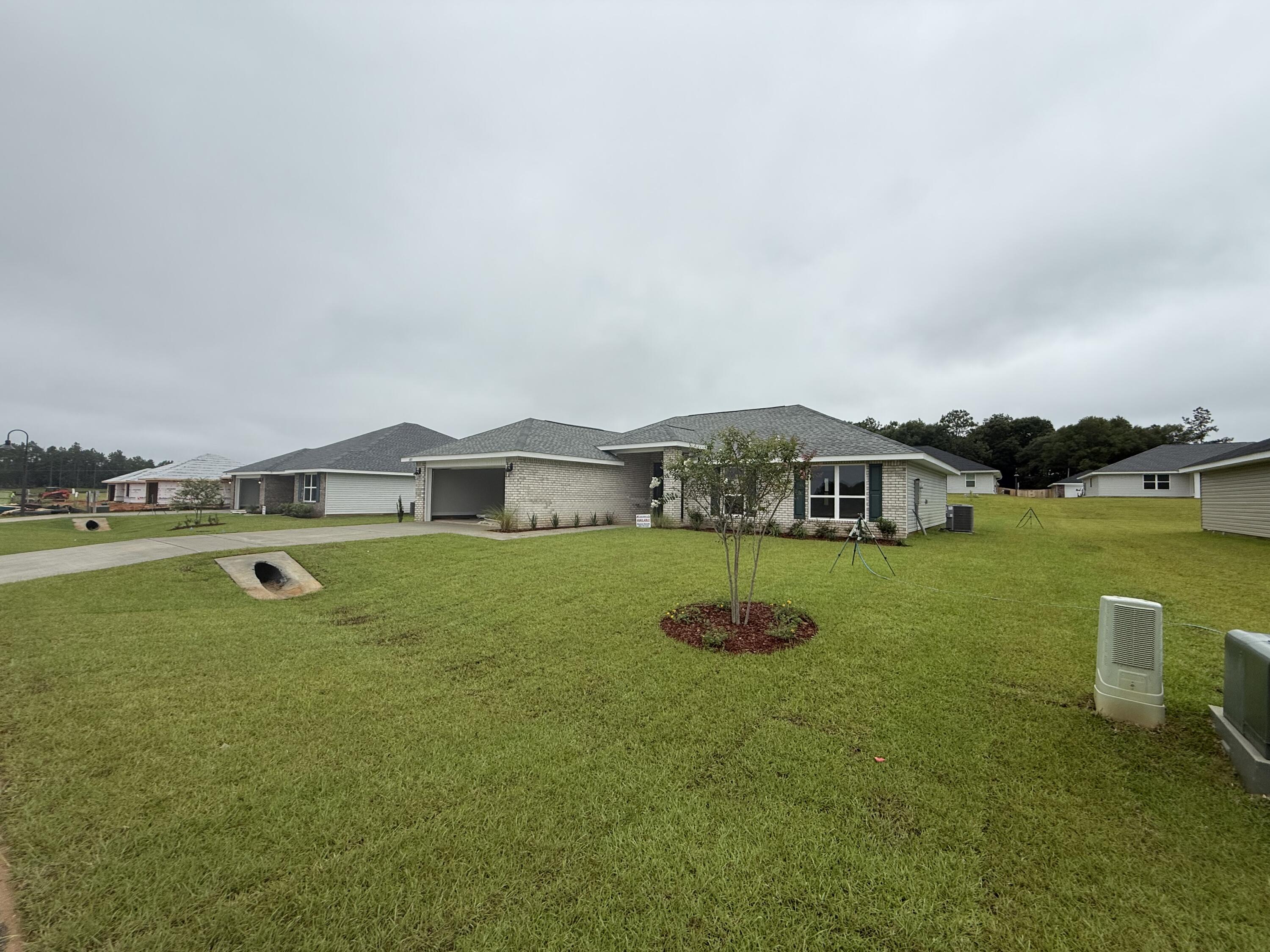 This 4/2 has a lot to offer! Good sized lot, fully sodded yard and professionally landscaped. The 2-car garage comes with electric garage door opener. The house is 3-sided vinyl with a brick front. This is a split bedroom plan. There is a dining area off the kitchen. All floors are carpeted except wet areas which have LVP.