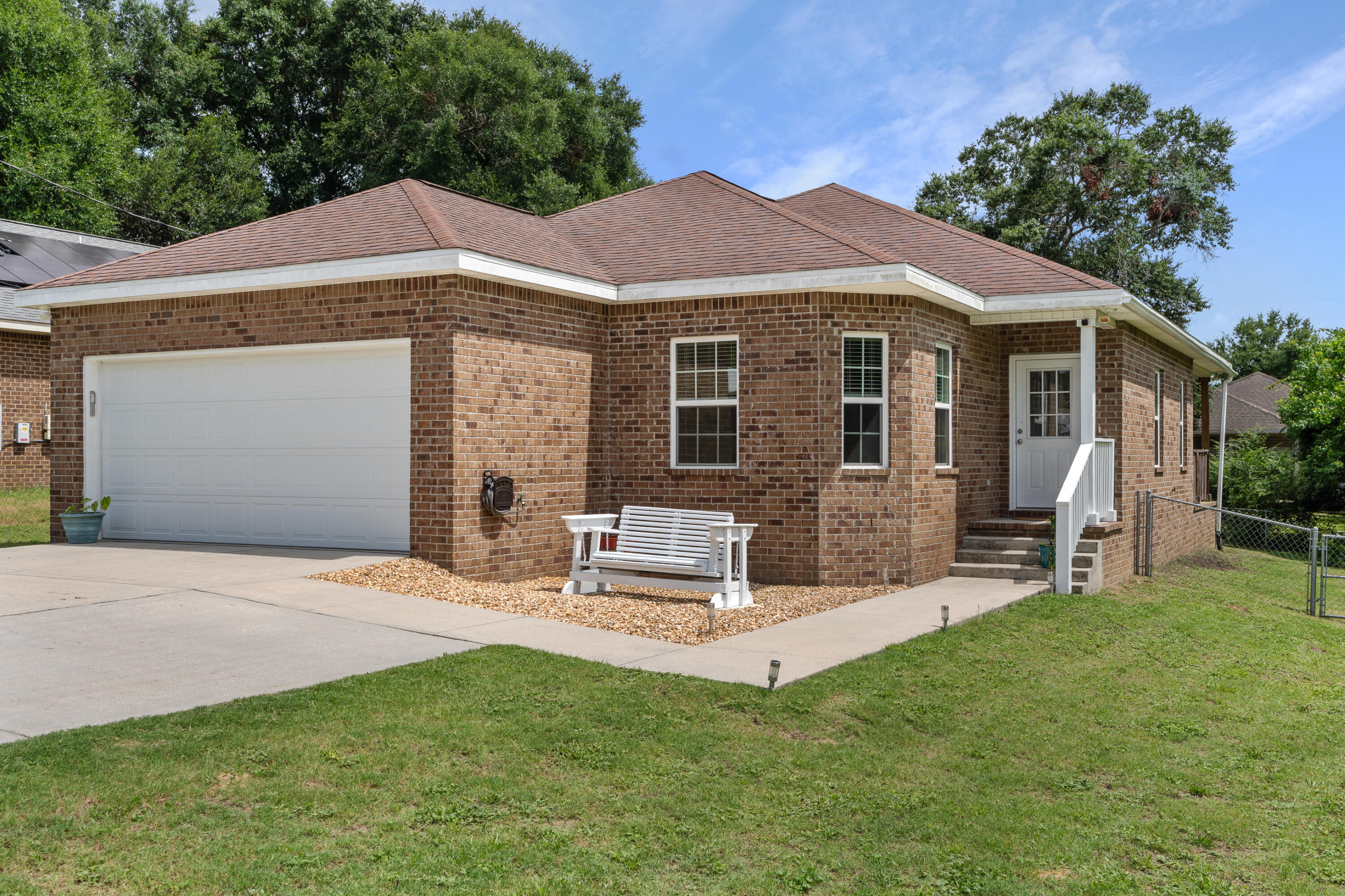 This adorable home features 9 foot ceilings, engineered hardwood in the living room and 14inch tile in the kitchen, dining, and bathrooms. Custom, soft-close cabinets in the kitchen and bathrooms offer plenty of storage. Bay windows, in the dining space off the kitchen, and the double French doors in the living room invite in natural light. French doors invite you onto the covered back patio and large fenced in backyard. The home's split floorplan separates the bedrooms; the primary bedroom sits just off the living space, with a large walk in closet, and the en suite bathroom features double vanity sinks, shower, water closet, and soft close cabinets; the linen closet offers plenty of storage. The other two spacious guest rooms are down their own hallway, past the kitchen and living room. The guest rooms share a hallway bathroom with shower/tub combination and single vanity sink. The mudroom/laundry room is adjacent to the guest hallway with washer and dryer hook ups and utilities storage. The laundry room leads out into the full size double car garage. The driveway offers plenty of parking; park your boat or camper on the oversized driveway. A freshly painted front entryway and porch swing welcomes you home. The outdoor patio furnishings will convey with the sale of the property. Welcome, take a look, and fall in love with this well kept home. Buyer to verify all deemed to be important.