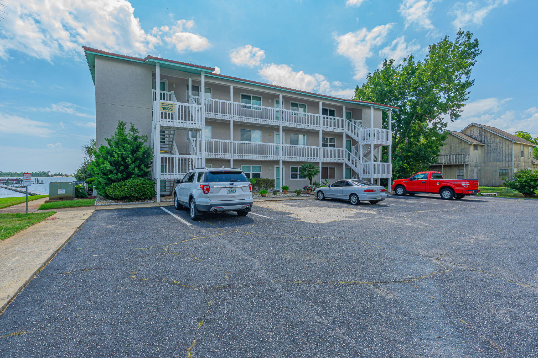Looking for a Waterfront Condo? This 3 bedroom, 2 bath, first floor condo might be the one for you! You'll have water views from your living room, kitchen and primary bedroom. The two guest bedrooms are perfect for the guests you will surely be hosting! The attractive, neutral-toned tile is throughout the home. For an additional fee, there are boat slips available for owners, via first come, first serve waiting list. There is storm protection for the water facing doors.