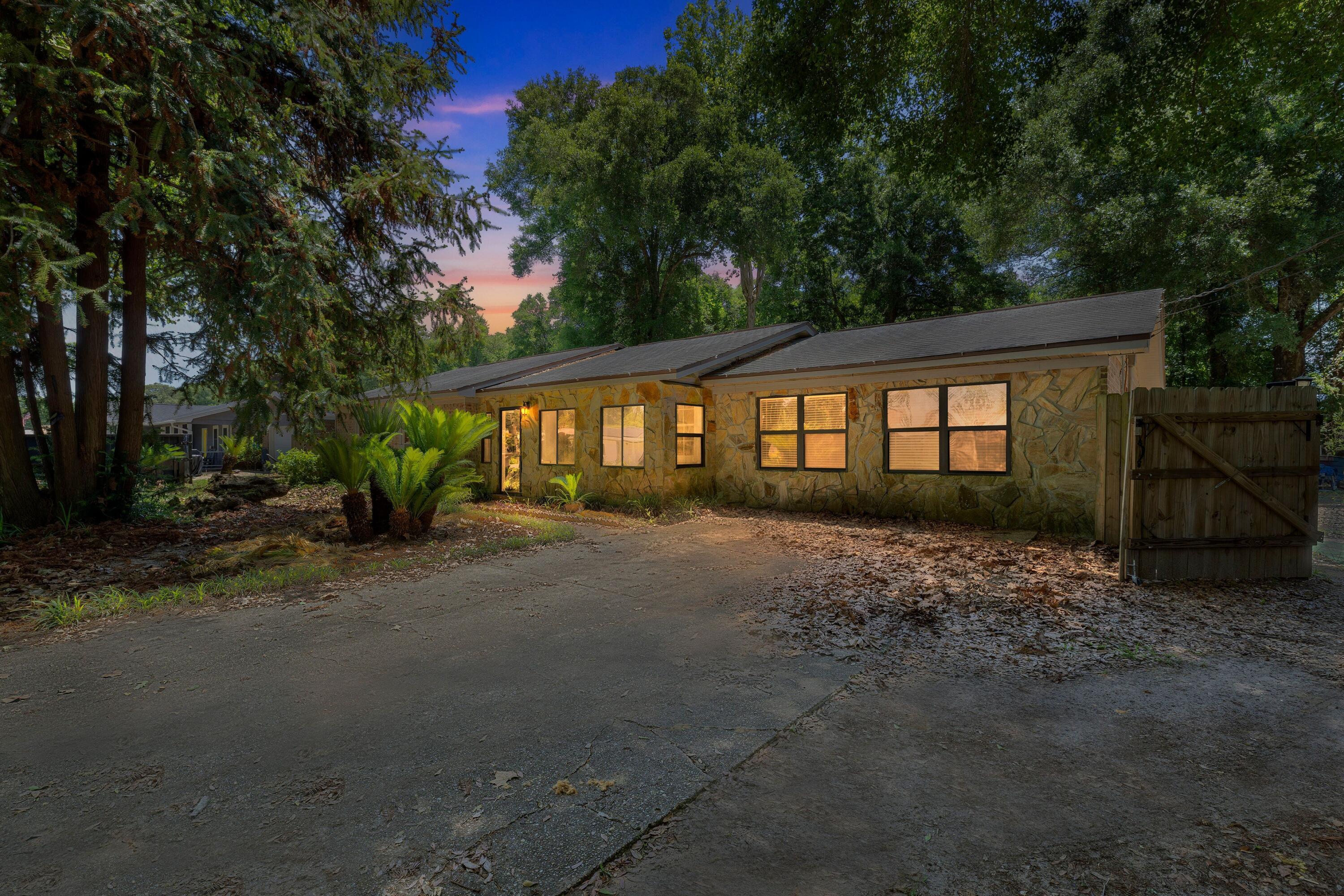 Huge price drop and motivated seller! This 3-bedroom, 2-bath home spans 1,775 square feet and sits on a spacious 0.33-acre lot in a quiet, peaceful neighborhood just 45 minutes from Pensacola Beach. With easy access to Pensacola and no HOA, this property offers flexibility and potential. The home features a 7-year-old HVAC system, a 2016 gas water heater, copper wiring, and a shingle roof approximately 15 years old. Inside, you'll find vintage charm with wood-paneled walls, stone fireplace, and retro kitchen ready for a modern makeover. This is a fixer-upper, being sold as an assignment of contract and will likely require cash or renovation financing due to condition. Short-term rentals are allowed, and the home is on septic with no flood insurance required. Contact listing agent today!