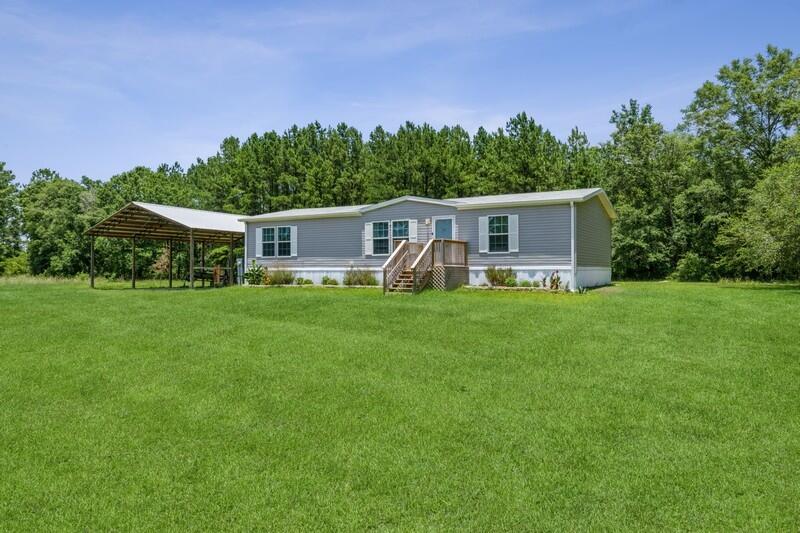 This home is a Country Charmer at its best! The home is only a few years old, has 3 bedrooms and 2 full baths. The kitchen is open, has lots of storage and counter space. Living room has an adorable built in entertainment center that matches the charm in the kitchen. To the right of the home is the 2 spare bedrooms with great walk-in closets and a full bathroom. On the left side of the home is a large laundry room and the spacious master bedroom. The en suite is a great size with a ton of storage space. Outside in the back is a great screened in porch to hang out on the cool nights. The large deck surrounds the above ground pool, perfect for any outdoor party. There is a huge, covered pole barn to the left of the home. The property is gorgeous and extremely peaceful, this won't last long!