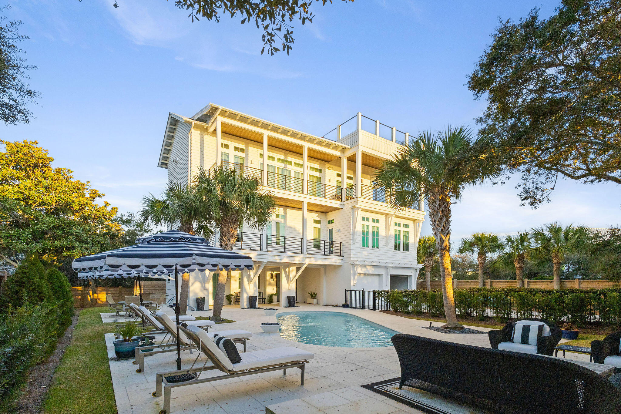 Introducing 27 White Sands Drive, an exquisite coastal retreat located near Grayton Beach in the tucked away community of Gulf Trace! This one-of-a-kind 5 bedroom, 5.5 bathroom home has been completely remodeled from top to bottom, with no expense spared and tons of square footage added to the original footprint. Panoramic Gulf views overlooking State Forrest will take your breath away from the 3rd floor open-concept kitchen and living, and 4th floor observation deck. The outdoor entertaining space features a private pool and large sunbathing patio complete with an outdoor fireplace perfect for enjoying cozy evenings. The first floor boasts a bunk room and full bath, that also serves as a pool bath for guests and oversized two-car garage with room to store all of your beach necessities, and a private elevator. Head up to the 2nd level where you will be greeted by your spacious, luxuriously designed primary suite with natural light pouring in and a spa-like bathroom. Also on this level, you will find 3 additional private king bedrooms, each with their own personality and ensuite bathrooms providing a private oasis for guests. The third floor is home to main living space featuring a modern fireplace as the focal point of the room and surrounded by open shelving and curated coastal furnishings, and gorgeous vaulted ceilings. Step over to the Chef's kitchen equipped with professional-grade luxury appliances, a custom range hood, custom cabnitry with ample storage, and a show-stopping oversized kitchen island with waterfall countertops and attached seating. Entertaining is made easy with additional seating for 6 in the formal dining room and wet bar for stocking your favorite beverages. The kitchen is complete with a butler's pantry providing additional storage and serving as a coffee bar. This home is a must see!