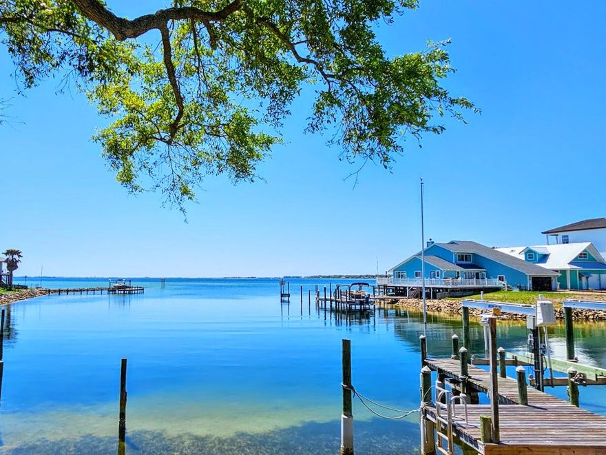 COASTAL CHARM WITH A TOUCH OF CAPE COD!  Experience Florida waterfront living at its finest in this stunning home, perfectly situated on a beautiful lot with mature oaks and panoramic views of the bayou and bay. Whether you're swimming, boating, kayaking, paddleboarding, or fishing, the deep, clear, and protected waters...the bayou is just steps away.  Enjoy your morning coffee, a waterside lunch, or evening sunsets from the expansive deck, where you can watch sailboat regattas or dolphins at play.  Inside, this move-in-ready home blends comfort & coastal elegance, featuring abundant natural lighting and breathtaking water views from every room (except the upstairs bath).  Home Features: **Primary Suite (Main Level): Stunning water views, walk-in closet, and private deck access. **Kitchen: Gas range, mobile island, Corian countertops, real wood cabinets, and a charming bay window with a built-in seating area. **Living & Dining: Open-concept space with two sets of sliding doors leading to the deck. ** **Guest Bedrooms (Upstairs): Each with sliding doors opening to a balcony overlooking the water. ** Outdoor & Structural Highlights: Deep-water dock and boat lift, Hardy board exterior for low maintenance, Brick-paved driveway and walkway, under-house storage for paddleboards, kayaks, and other water toys, Reinforced foundation for stability, Finished 2-car garage with epoxy-coated floors. ** Perfectly located in a well-established neighborhood, its convenient to Eglin, Hurlburt, Duke, and SFG complex as well as the airport, shopping, schools, medical facilities, restaurants, area parks, golf courses, and the beautiful white sandy beaches.  This home is more than just a place to live - it's a waterfront retreat designed for relaxation, adventure, unforgettable coastal moments - IT'S A PLACE TO CALL HOME!  Buyer(s) is responsible for verifying ALL data and information including lot size and room measurements as it is deemed to be reliable but not guaranteed.