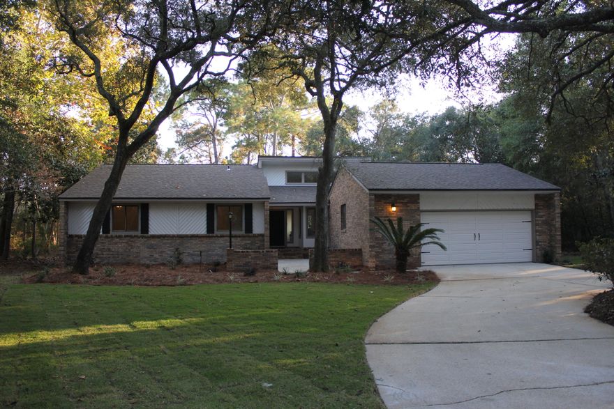 Welcome Home... This beautifully renovated home is move in ready. The only thing missing is you! This spacious home features 4 bedrooms & 2 1/2 baths with new hardwood floors through out the entry, living & dining area. The custom kitchen features new shaker style cabinets with quartzite counter tops & stainless appliances. The master suite offers a large walk in closet & access to the large back deck. Relax in your newly remodeled master bath with new vanities & custom tile walk in shower. The additional bedrooms all feature new carpet & the additional baths feature new tile. Brand new roof!! All situated on a large wood lot close to the bay in Bluewater Bay.