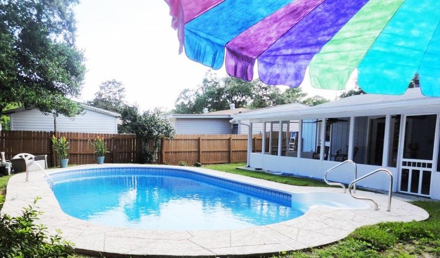 Paradise is waiting! This lovely home has been updated in every way. Ready for your own private pool to get away to after work each day? The back yard is fenced and gated for privacy with a gorgeous 23,000 gallon pool with a brand new liner. The backyard also has a new sprinkler system and some new sod. Inside, you'll love the kitchenit has been updated with new Shaker cabinets, gorgeous granite countertops, a new stove, deep sink, dishwasher and microwave. From the kitchen, you get lots of light from the French doors overlooking the screened in porch and the pool. Inside, there is a huge open room with a gorgeous fireplace with plenty of room for your family and furniture. All the lighting and fans in the home are new as well. Plus there is a brand new Air Conditioning syste