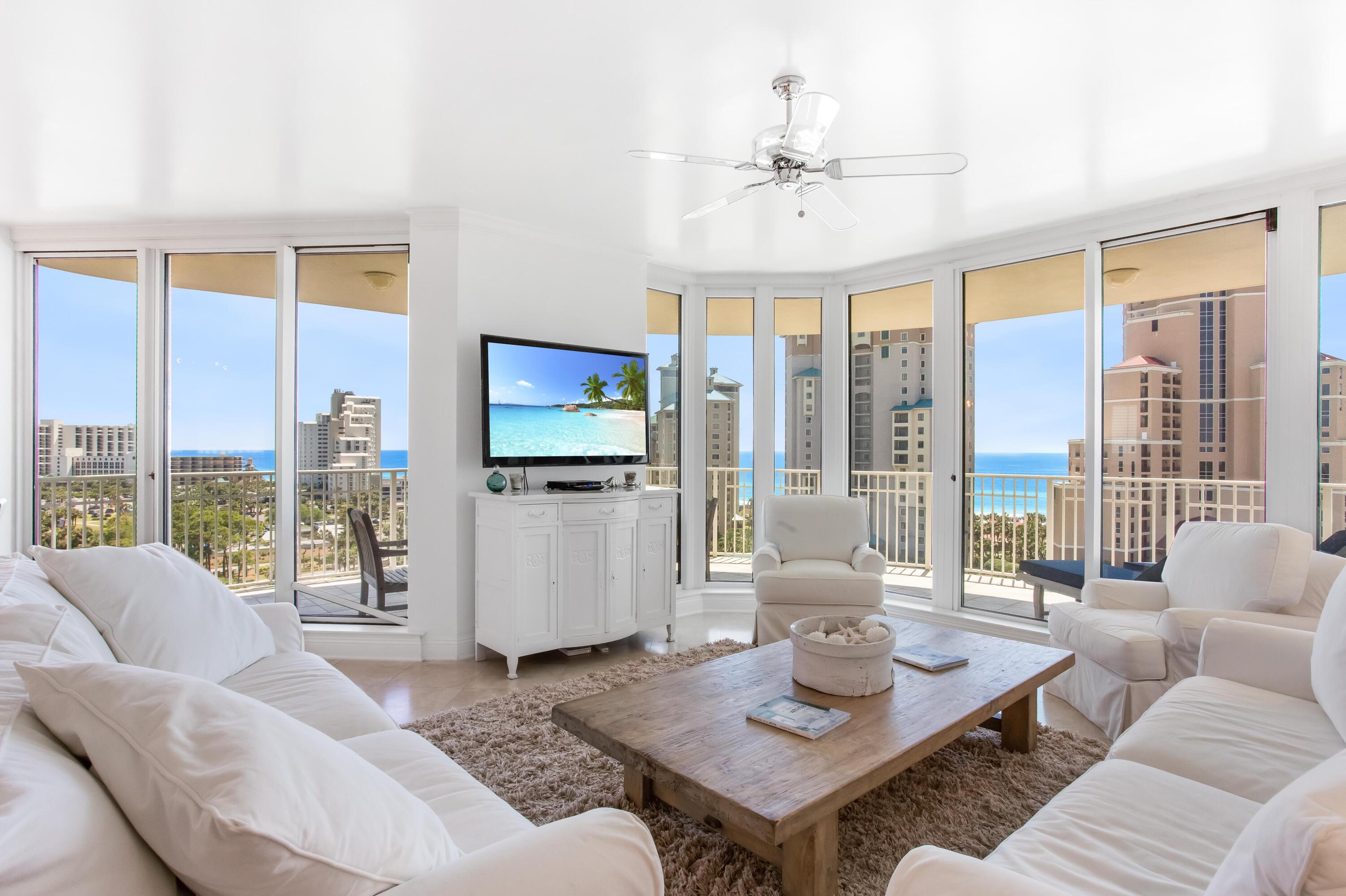 Exquisite 10th floor corner condo with north & south balconies and floor to ceiling windows that showcase panoramic views of the gulf, lake, golf course and bay. Elegant, coastal chic decor, artwork and furnishings light up each room. Tile flooring flows throughout each room. The kitchen is beautifully remodeled with white cabinets and countertops and stainless steel appliances. The master bedroom offers a large walk-in closet, space for a sitting area, and private access to the south balcony with ocean views. The fully tiled (floor to ceiling) master bath has a large spa tub, separate shower, and double vanity area. Both guest bedrooms have private remodeled en-suites and access to a shared balcony with front row seats to the seasonal fireworks show at the Village of Baytowne Wharf.