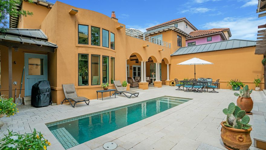Investor alert! Elegant Tuscan-inspired Italian villa in the sought-after gated community of Destiny East. This incomparable Tuscan Villa is truly an entertainer's dream and one of the most unique properties in Destiny East. Exquisite Italian architecture, impeccable design, Venetian plaster finishes, casement windows, 19th century imported antique doors and artful touches throughout are just a few of the hallmarks of this home. This exquisite 'Villa by the Sea' estate was thoughtfully designed with multi-generations in mind as a second home, primary residence or income producing investment property, with two ensuite bedrooms and 1/2 bath in the main house, two bedrooms and full bath in the detached carriage house and newly added fifth bedroom/office located off the courtyard Every corner of this unique home is reminiscent of the country estates of Italia from the imported antique front door patterned after the Duomo in Florence to the travertine lined floors and sweeping staircase as you enter the home. Truly an entertainer's dream, the open concept living area with beamed ceiling, gas fireplace and French doors lining the back of the home lead into a private outdoor courtyard with heated lap pool, covered veranda and grilling area. An impressive separate two-story glass enclosed dining area with four sets of chandeliers is ideal for indoor or outdoor entertaining. The award-winning master chef's kitchen, designed by Atlanta-based Frank Neely Design Associates, features a barrel-vaulted ceiling with Venetian plaster, tumbled brick backsplash, concrete countertops, freestanding island, separate wine cooler and ice maker and luxury Subzero and Thermador appliances

In the main house, a grand staircase leads to the second floor where you will find an ensuite guest bedroom and primary suite that features a sitting room, soaking tub, separate shower, coffee bar, separate dressing area/office on the second floor. French doors accessible via both bedrooms open onto a private second level terrace that overlooks the courtyard, heated pool and detached carriage house that houses two bedrooms, full bath, sitting area and kitchenette.

This exquisite turnkey home comes fully furnished with a few exclusions noted in documents section. Conveniently located minutes from sugar sand beaches and turquoise waters, world-class restaurants and shopping and champion golf courses.  Destiny East community has ample neighborhood amenities that includes club house, multiple pools, tennis courts, movie theatre, outdoor grills, fully equipped gym and new playground. Rental projections of more than $150K make this a compelling income producing vacation property. Survey, improvements, cost-to-own and rental projections available to download in documents section. Buyer to verify all dimensions.

