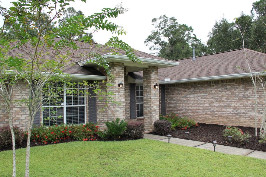 Escape to your new private, 1/2 acre wooded lot in the heart of Pensacola.  The upgrades and features of this home make this a truly special getaway.  Enjoy your own oasis in the master bath with the custom porcelain walk-in shower and rainfall shower head.  In addition to the recently installed granite countertops and luxury vinyl plank flooring throughout, the kitchen boasts spacious cabinets and a tucked away breakfast nook.  Entertain your family and friends with all the capacity afforded by the formal dining and living rooms.  Take in quiet nights nestled by the wood-burning fireplace with a view of the wildlife at your backdoor.  Morning coffee can also be enjoyed from the comfort of your secluded patio.  This is the one you've been waiting for - don't miss this beautiful property!