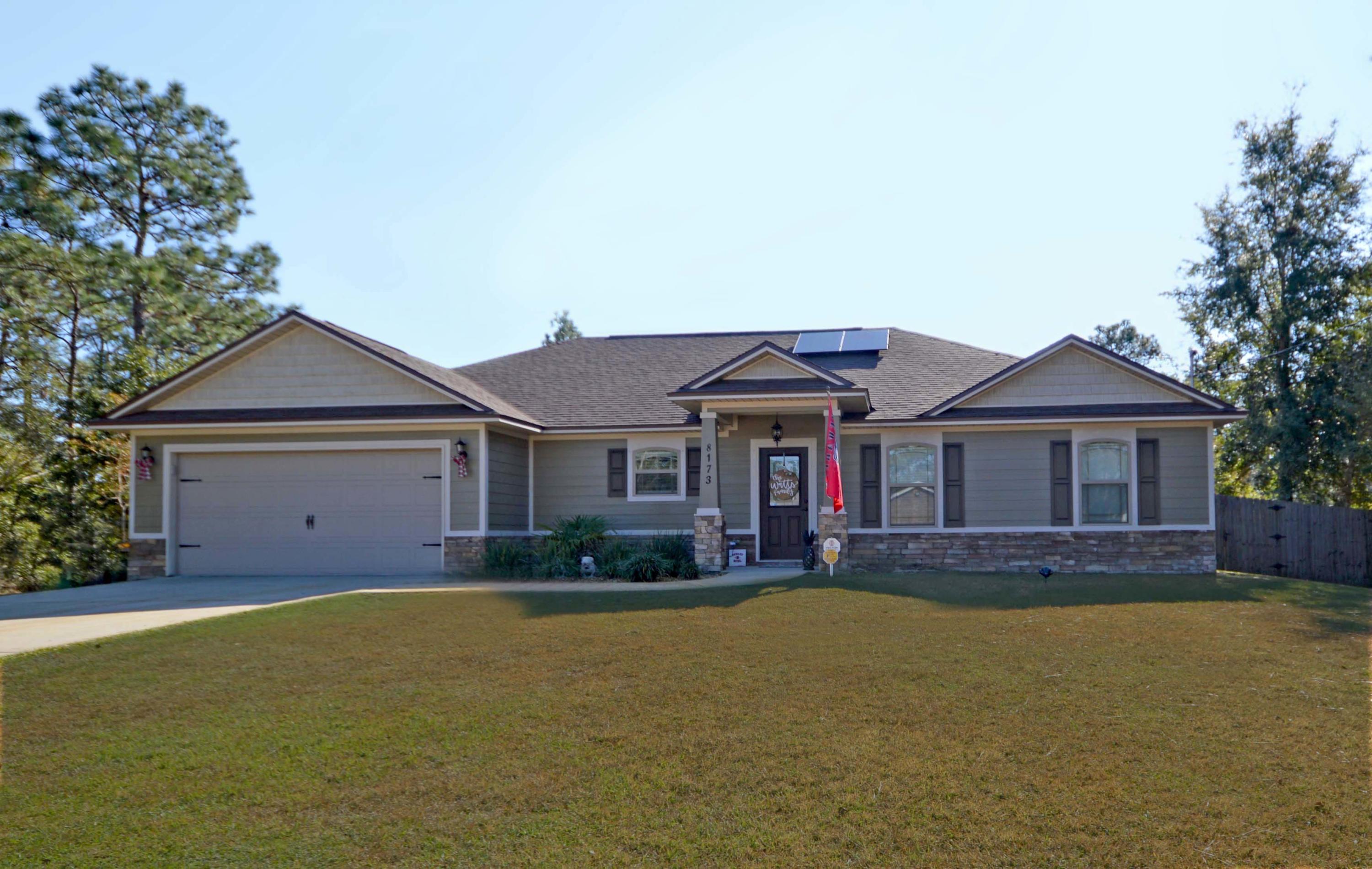Welcome to your beautiful and Energy Efficient craftsman style home with NEW Solor Panels for low maintenance utilities! Home is located in the center of Navarre close to beach, shops and restaurants; The kitchen has beautiful granite, a coffee bar with wine refrigerator, soft close custom cabinets, stainless steel appliances, and indirect LED lighting! Kitchen flows into the spacious open living area where floors are laminate wood, tile in wet areas and carpet in bedrooms; Living area has lots of light with inside door blinds, 5'' Base boards, Plantation shutters and more! Colors throughout home are neutral earth tones; Architectural Shingles, Treyed ceilings in living area and Master Bedroom; Master Bedroom has large closet with pocket doors; Master Bath has beautiful tiled glass shower
