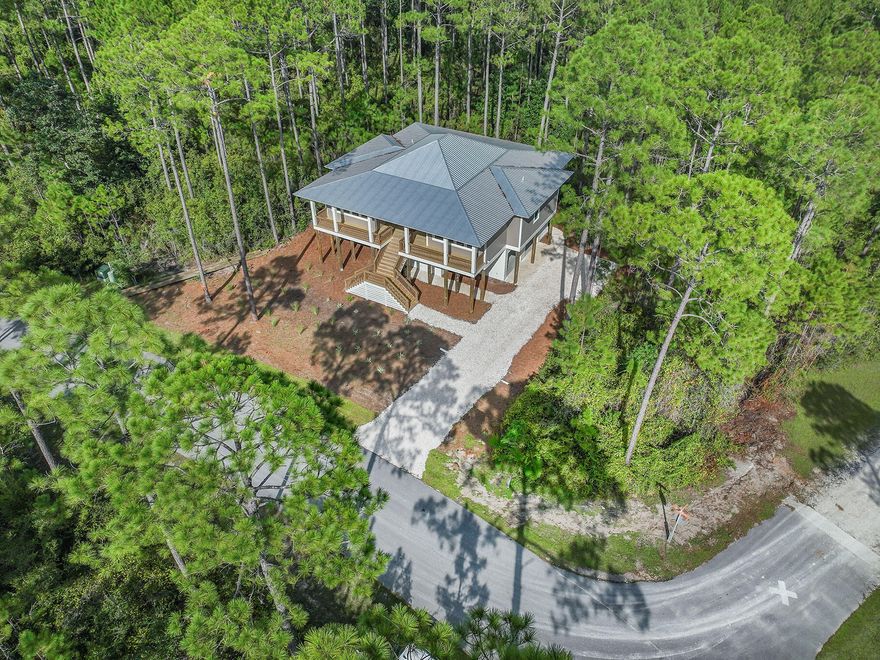 Located within the highly sought after waterfront gated community of RiverCamps is this brand new, JUST COMPLETED gorgeous home built by highly acclaimed builder Corestruction. The home boasts 2469 sq ft. 3 large bedrooms, each with their own full bath and walk-in closets. The home is open and bright with lots of windows, 10 foot ceilings and 8 foot doors, a powder bath, office and high-end finishes. Enjoy the serene beauty of the neighborhood from 740 sq ft of decking including a large screened backporch. Under the home is a 2 car garage and over 550 sq ft of storage. All of this located over 1/2 acre. RiverCamps is surrounded by 3 bodies of water, West Bay, Intracoastal and Crooked Creek and consists of 1500 acres, 1000 of which are committed to conservation with the remaining 500 acres