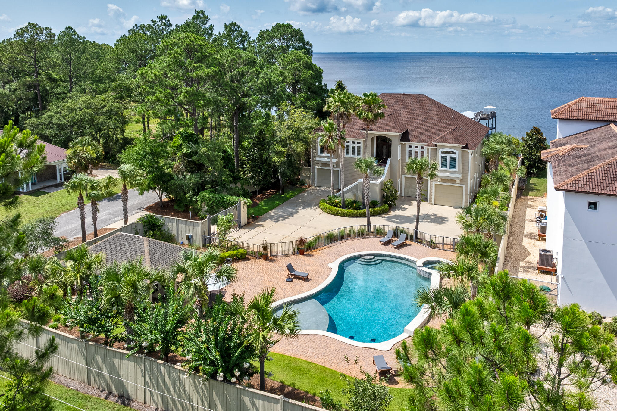 Discover your dream waterfront oasis just minutes from the pristine 30A beaches! This stunning 5BR/3.5BA bayfront estate offers unparalleled privacy and luxury resting on nearly half an acre with 100' of waterfront directly on the Choctawhatchee Bay and deepwater access from the newly constructed private dock. Making this fully furnished property a truly turnkey lifestyle, a 2018 Sea Fox Avenger included with purchase! In addition, the property features a heated resort-style pool, spa, and pool deck, all nestled within a custom-built outdoor pavilion perfect for entertaining or simply unwinding in your private paradise sheltered by an 8' privacy fence and accessed through a gated entrance. Step inside to find elegant yet comfortable spaces throughout the nearly 4,300 square feet with sweeping bay views at every turn. The primary living and dining spaces on the second level feature custom built-ins, a new electric fireplace, 18' sliding doors that open to an expansive waterfront balcony with remote retractable screens and a summer kitchen with built-in Green Egg. Just off the family room, you'll find a well equipped chef's kitchen with professional grade stainless-steel appliances, a subway tile backsplash, open shelving, custom cabinetry, a prep island, and a counter height breakfast bar. The waterfront master suite offers direct access to a balcony with a hanging bed swing. Two additional guest bedrooms are located on the second level with two more on the first. Also on the first level, you'll find a massage room, and a secondary living space featuring a dining space and 18' slider doors to a spacious covered patio. The three-car oversized garage with ample storage space accommodates all your needs.

Additional upgrades include new pump, piping and sprinkler heads for the sprinkler system, updated outdoor lighting, upgraded camera system, speakers, and whole home Wi-Fi, new wood shelving in closets, new outdoor fans, lighting and electrical connection at the pool pavilion, a custom designed stain glass window on the balcony, and an upgraded laundry room with floating shelving, an accent wall, and a large sink. This home is move-in ready and perfectly designed for family fun and entertaining. Embrace the ultimate bay house experience and live the dream!