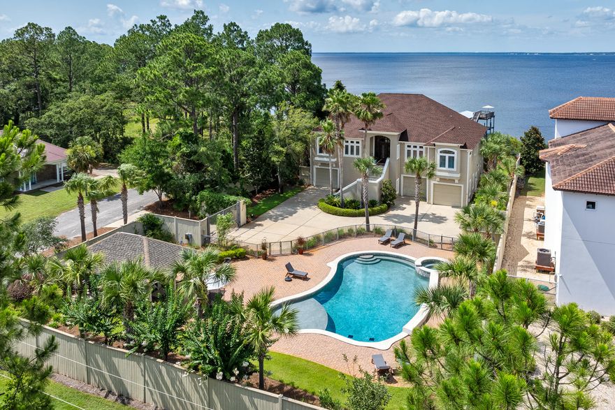 Discover your dream waterfront oasis just minutes from the pristine 30A beaches! This stunning 5BR/3.5BA bayfront estate offers unparalleled privacy and luxury resting on nearly half an acre with 100' of waterfront directly on the Choctawhatchee Bay and deepwater access from the newly constructed private dock (A 2018 Sea Fox Avenger included with purchase!). In addition, the property features a heated resort-style pool, spa, and pool deck, all nestled within a custom-built outdoor pavilion perfect for entertaining or simply unwinding in your private paradise sheltered by an 8' privacy fence and accessed through a gated entrance. Step inside to find elegant yet comfortable spaces throughout the nearly 4,300 square feet with sweeping bay views at every turn. The primary living and dining spaces on the second level feature custom built-ins, a new electric fireplace, 18' sliding doors that open to an expansive waterfront balcony with remote retractable screens and a summer kitchen with built-in Green Egg. Just off the family room, you'll find a well equipped chef's kitchen with professional grade stainless-steel appliances, a subway tile backsplash, open shelving, custom cabinetry, a prep island, and a counter height breakfast bar. The waterfront master suite offers direct access to a balcony with a hanging bed swing. Two additional guest bedrooms are located on the second level with two more on the first. Also on the first level, you'll find a massage room, and a secondary living space featuring a dining space and 18' slider doors to a spacious covered patio. The three-car oversized garage with ample storage space accommodates all your needs.

Additional upgrades include new pump, piping and sprinkler heads for the sprinkler system, updated outdoor lighting, upgraded camera system, speakers, and whole home Wi-Fi, new wood shelving in closets, new outdoor fans, lighting and electrical connection at the pool pavilion, a custom designed stain glass window on the balcony, and an upgraded laundry room with floating shelving, an accent wall, and a large sink. This home is perfectly designed for family fun and entertaining. Embrace the ultimate bay house experience and live the dream!