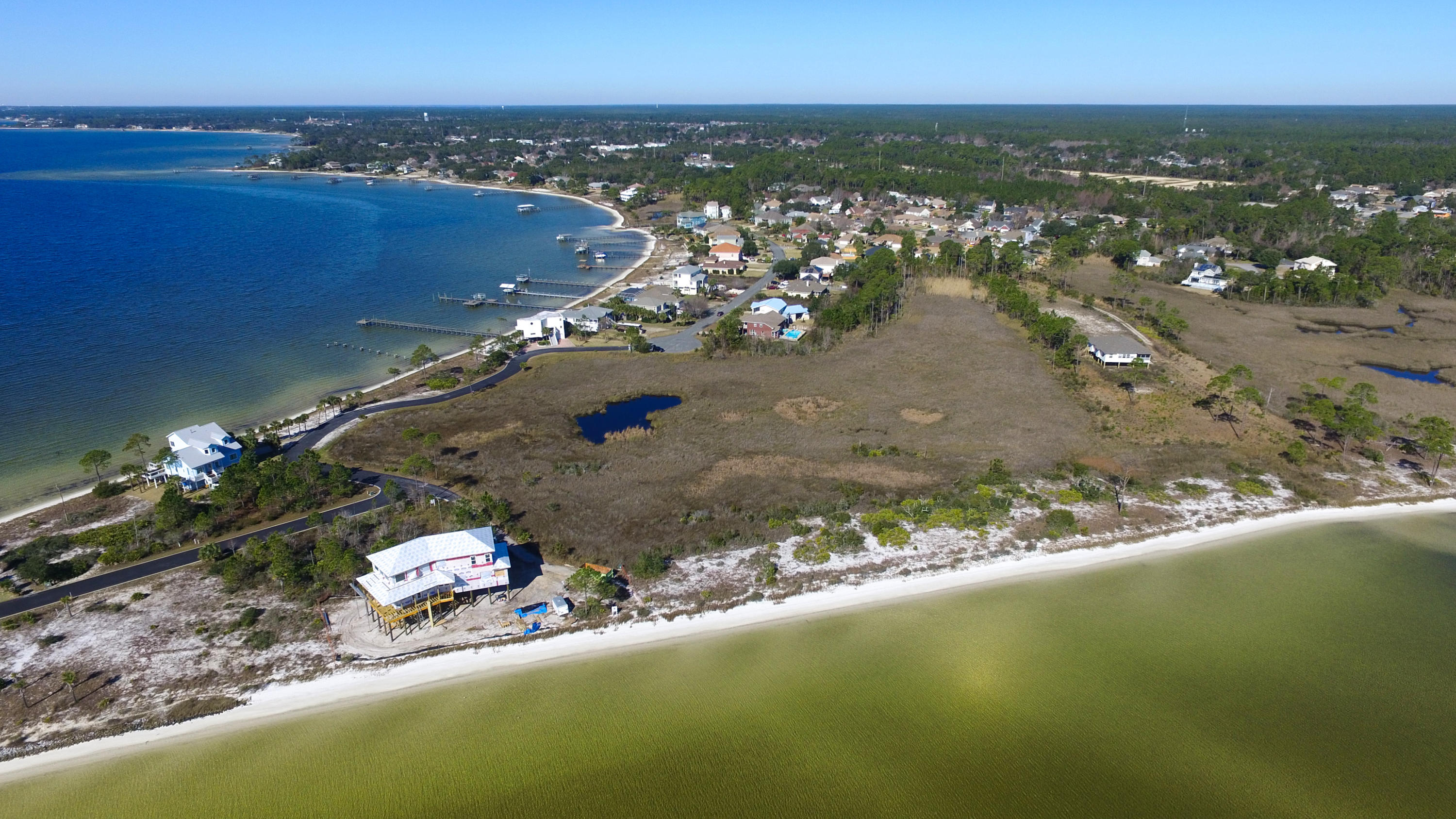 This beautiful waterfront lot on the Intercoastal waterway is ready for the retiree or the investor ready to build the home of their dreams. The east sunrise views and the westerly sunset views cannot be described. Your lot will be in the secluded gated subdivision of Sandy Pointe in Emerald Pointe. Total privacy with you and nature! Wake up and take a stroll with your dog on your own white sandy beach or take a swim in the sound. This unique lot has endless possibilities! Just 10 minutes to Navarre Beach and a 30 minute boat ride to Destin East Pass for the best fishing in the world.