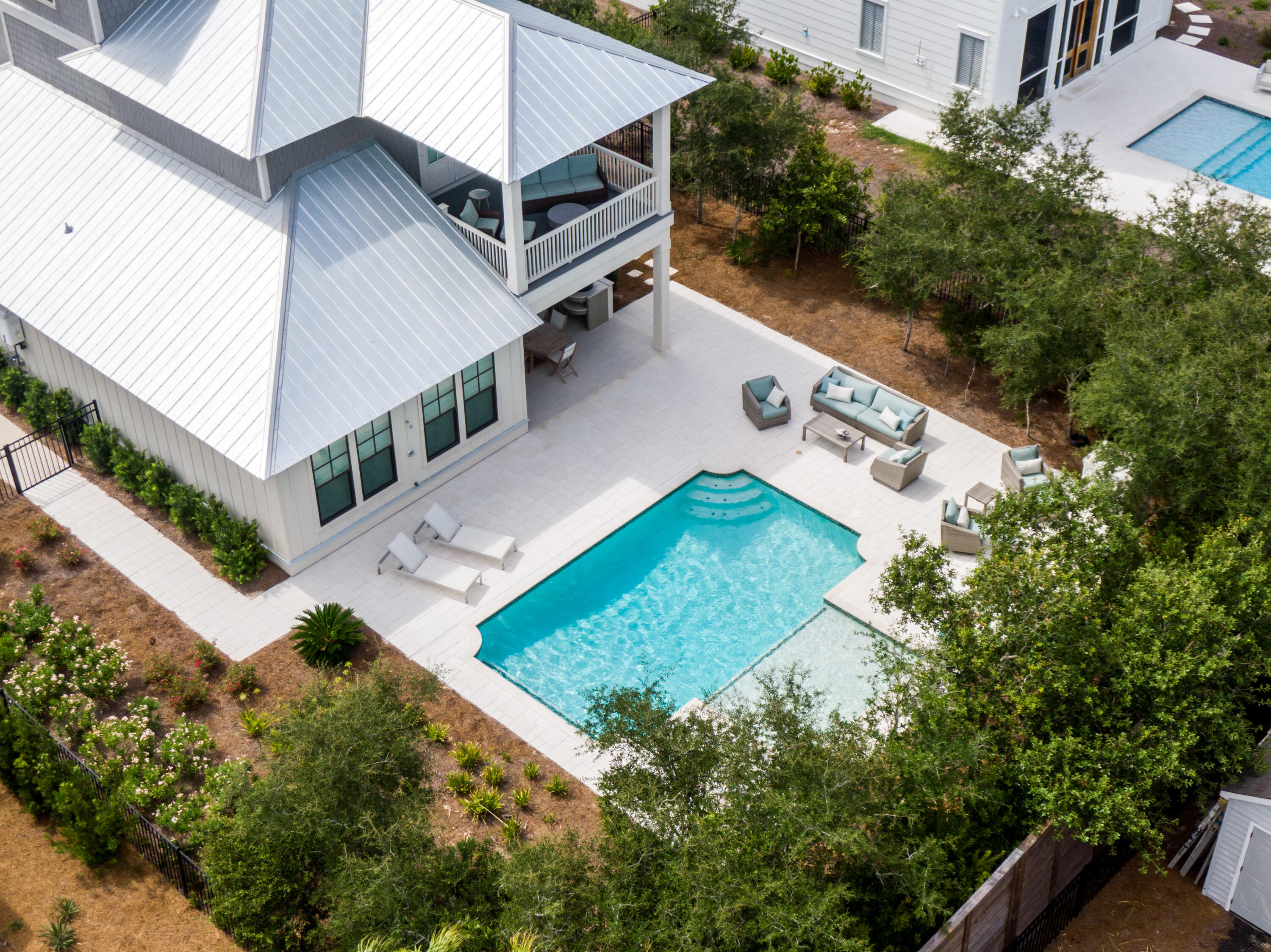 Discover the luxurious 30A coastal lifestyle from this peaceful haven. This exceptional property is positioned on a beautiful street which backs up to the nature preserve. Beautifully designed, the home offers a modern blend of indoor and outdoor living spaces. Serving as a perfect seaside retreat, 134 Walton Gulfview features exclusive deeded beach access, an outdoor kitchen, outdoor fireplace and a private heated pool. The chef's kitchen showcases Thermador appliances and quartzite countertops. Positioned just minutes from Alys Beach, Rosemary Beach & Seacrest Beach, this home sits in the perfect location to enjoy a peaceful sanctuary while also being close to all the top dining, shopping and entertainment options on the east end of 30A. The heart of this home is the expansive first floor great room along with the amazing outdoor dining area. The first level features an elegant primary suite. The second floor offers two additional primary suites. And the top floor has a gorgeous built-in bunk area. Each bedroom has their own ensuite bathroom. And the property boasts multiple balconies and covered porches. Offered fully-furnished, this property can be a lucrative investment property and comes with strong actual rental history. Explore a sanctuary designed for relaxation, connection and unforgettable memories on the coast.