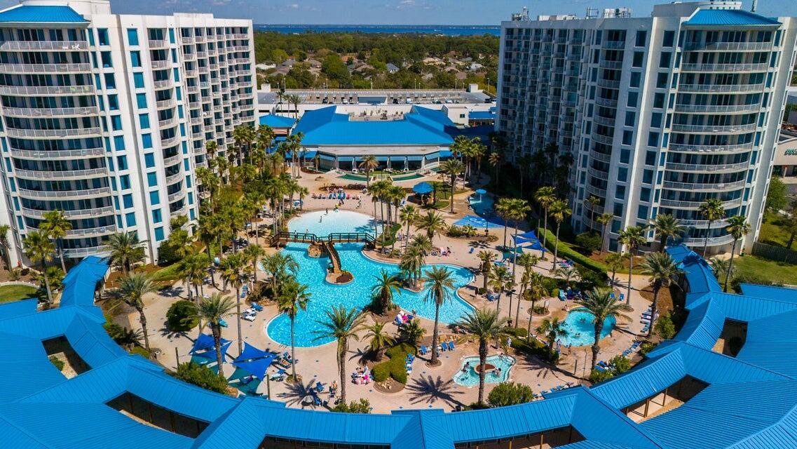 One of only 14 Villas! Out of 416 units at The Palms of Destin, just 14 are Villas. Own this rare, poolside Villa--fully furnished and turn-key ready for rental income just in time for summer. Steps from lush tropical landscaping and the stunning 11,000 sq. ft. lagoon pool. Enjoy 10 ft. ceilings, nearly 1,400 sq. ft. of open-concept living with walk-in/walk-out access, lagoon views, and 5-star amenities. Features include a spacious master suite with ensuite bath, separate laundry room, and double sliding doors. The Palms offers an on-site coffee house, restaurant, tiki bar, gym, new grill area, pickleball, tennis, and basketball courts.