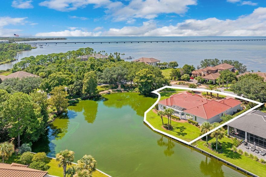 MEDITERRANEAN LAKEFRONT SANCTUARY - YOUR PRIVATE RESORT AWAITSWelcome to the home where every day feels like a vacation.Nestled on one of Regatta Bay's most coveted lakefront parcels--nearly half an acre of pure paradise--this stunning Mediterranean estate offers something increasingly rare: space, serenity, and sweeping water views that will take your breath away.A HOME THAT'S READY FOR YOUWith a brand-new premium concrete tile roof installed in 2025--a $96,800 investment offering hurricane-rated protection and a 50+ year lifespan--this home brings immediate peace of mind and insurance savings. The pool has been beautifully resurfaced with a new pump, ready for your first sunset swim. This is turnkey lakefront living at its finest. THE MOMENT YOU ARRIVE
A graceful circular driveway welcomes you home, setting the tone for what lies ahead. Brick pavers lead to an expansive three-car garage (with room for your golf cart), while hand-laid travertine tiles guide you to the grand entrance. Before you even step inside, you'll feel itthis is somewhere special.

ARCHITECTURE THAT CAPTIVATES
Step into a world of effortless elegance. Leonardo travertine tile flows into rich Brazilian hardwood that carries you through sun-drenched rooms, each one opening to tranquil lake views. Decorative tray ceilings with crown molding add sophistication, while floor-to-ceiling windows frame the shimmering 5-acre lake like living artwork.

WHERE ENTERTAINING BECOMES EFFORTLESS
The heart of this home is the chef's kitchena space designed for both culinary creativity and connection. Imagine preparing dinner at your six-burner gas range, wine cooler within easy reach, while friends gather at the breakfast bar. Conversation flows naturally into the family room, where a cozy fireplace adds warmth on those rare cool Florida evenings.

And just beyond? Your screened pool and spa overlooking the lake, where the party seamlessly continues under the stars.

WELLNESS & LUXURY, PERFECTED
This home understands that true luxury is about how you feel. Retreat to your private saunaa rare amenity that transforms your daily routine into a spa experience. The executive study offers the perfect work-from-home sanctuary. Three bedroom suites, each with private baths, ensure everyone feels pampered.

The master suite is your personal haven. Wake to lake views, step onto your private lanai with morning coffee, and unwind in your oversized custom walk-in closet. The spa-inspired bath features a jetted tub, separate shower, dual vanities, and a dedicated makeup stationbecause you deserve to feel like you're at a five-star resort every single day.

THOUGHTFULLY UPDATED FOR MODERN LIVING
" Three-zone climate control with premium 3-year-old Trane HVAC systemseveryone stays comfortable
" Recently resurfaced pool with new pumpready for immediate enjoyment
" 2-year-old water heater for efficiency and reliability
" Tinted Pella windows and plantation shutters throughout for beauty and comfort
" New concrete tile roof (2025) with hurricane protection and decades of worry-free living

THE REGATTA BAY LIFESTYLE - LIVE WHERE OTHERS VACATION
Beyond your private oasis, the championship golf course beckons. The yacht club awaits. Tennis and pickleball courts call your name. Enjoy lakefront clubhouse dining, the community pool and playground, all within your gated, secure community.

Designer shopping and dining at Destin Commons? Across the street. World-class Emerald Coast beaches? Minutes away. Destin Executive Airport for weekend getaways? Just down the road. This is the golf cart lifestylewhere convenience meets coastal elegance.

THE OPPORTUNITY OF THE SEASON
At $1,399,999, this lakefront estate offers exceptional value in Northwest Florida's most prestigious no-short-term-rental community. With one of the largest lots in Regatta Bay, mesmerizing dual water views (lake and bay), a brand-new roof, resort-style amenities including the rare sauna, and a seller ready for their next chapterthe timing is perfect.

This isn't just a home. It's your invitation to live the Emerald Coast dream.

Golf cart includedbecause that's just how we roll in Regatta Bay.

KEY FEATURES:
2025 Premium Concrete Tile Roof 
 $96,800 investment 
three year warranty on installation and workmanship 
Hurricane-rated with 50+ year lifespan
Immediate insurance savings for buyers
Turnkey lakefront living on 5-acre lake
Established seawall to protect the lakeshore and your investment
" One of the largest lots in Regatta Bay (.45 acre)
" Dual water views: lake and bay
" Private sauna - rare amenity
" Circular brick paver driveway with plenty of parking spaces
" Recently resurfaced pool with new pump
" 3-car garage with golf cart space
" Leonardo travertine and Brazilian hardwood flooring
" Chef's kitchen with 6-burner gas range
" All 3 bedroom suites have private baths
" Executive study
" 3-zone Trane HVAC (3 years old)
" Golf cart included

Ready to experience lakefront living at its finest? Contact us today to schedule your private showing or watch for frequent Open Houses.