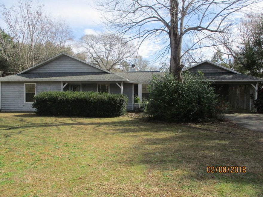 This REO property is located walking distance from the New Publix, movie theater and High School. Built in 1985, this 1665sf home boasts a large brick fireplace in the living room and large master suite with bath. Home has a total of 3 bedrooms and 2 baths, a kitchen/Dining area with bay window and indoor laundry. Outside, this home is cedar on the front of the home and wood siding and trim around the remaining. There is an attached covered carport as well with extra storage for yard equipment and tools. Home needs some work so therefore will not qualify for all types of financing. Call to see this one today!