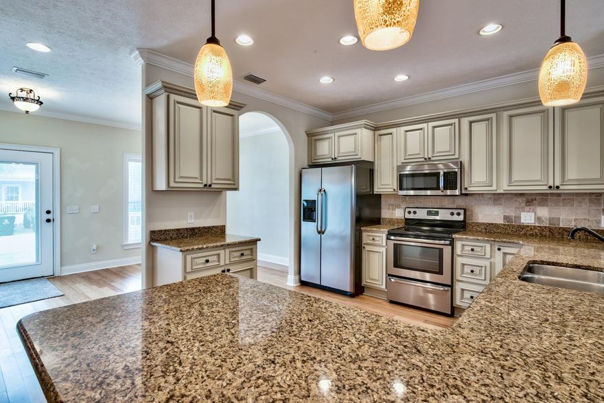 All you have to do is move in and head for the BEACH! This pre loved home has been freshly painted from the walls to the trim. Carpet professionally cleaned and both decks restained. You can find this spacious home in a quaint and quiet gated community of Paradise Grove. Located on the North side of Hwy 98 just minutes from Pier Park, WalMart and Publix. Trying to catch a flight? It's about 15 min drive to ECP airport!
The Master bedroom is located on the 1st floor, has amazing tiled walk in shower, Jacuzzi tub with in line heater and granite double vanity. Kitchen has solid bamboo floors throughout, granite counter tops and custom cabinets. 2nd floor and stairs have a plush carpet. $2000 Flooring Allowance. A recreation room is large enough for a regulation pool table, wired for projector TV..watch the game on a 9 ft screen! 
Exterior features rot resistant hardi siding, maintenance free vinyl trim.
The roof has spray foam roof insulation and insulated windows -  an Energy saving features! 
  Dual zone AC..set dift temp upstairs/down..electromagnetic/UV filter in AC duct..kills mold,viruses,bacteria.