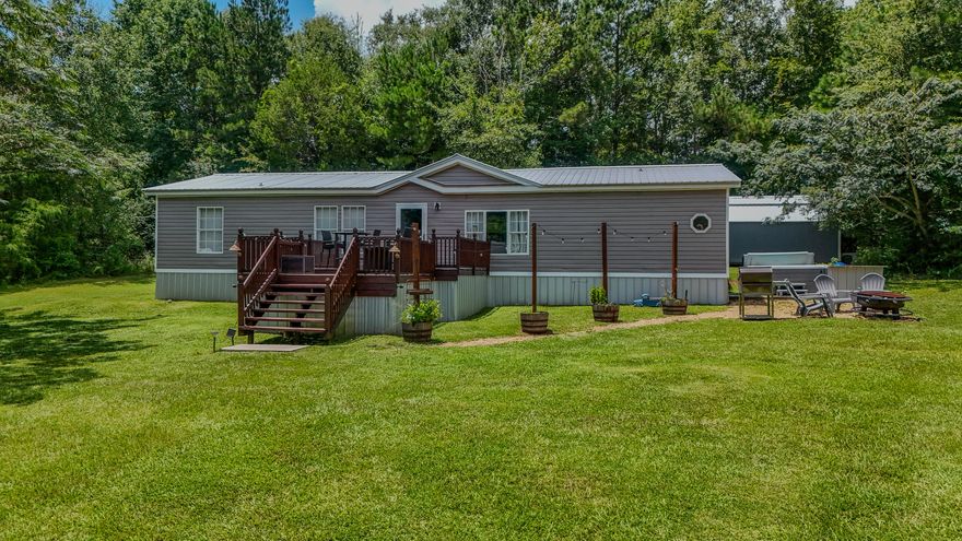 This impeccably maintained home sits just 8 minutes from Hwy 331 S. making it a great location for commuting to a multitude of places including the beaches of South Walton (45 minutes), Egin AFB (45 minutes) or Interstate10 (10 minutes). Upgrades to this 3 bedroom, 2 bath home include custom kitchen cabinets, one year old vinyl siding with Tyvek wrap underneath, and a 3 year old metal roof with water rubber waterproofing underneath.  Outside you will find an inviting hot tub on concrete slab, a 32x40 pole barn with a 12x32 insulated bay with concrete flooring and a 12x24 double lofted build-rite building. Another gem on this property is a 12x32 tiny home, double lofted and completely renovated. Additional acreage available with MLS#982575 and/or MLS#982576