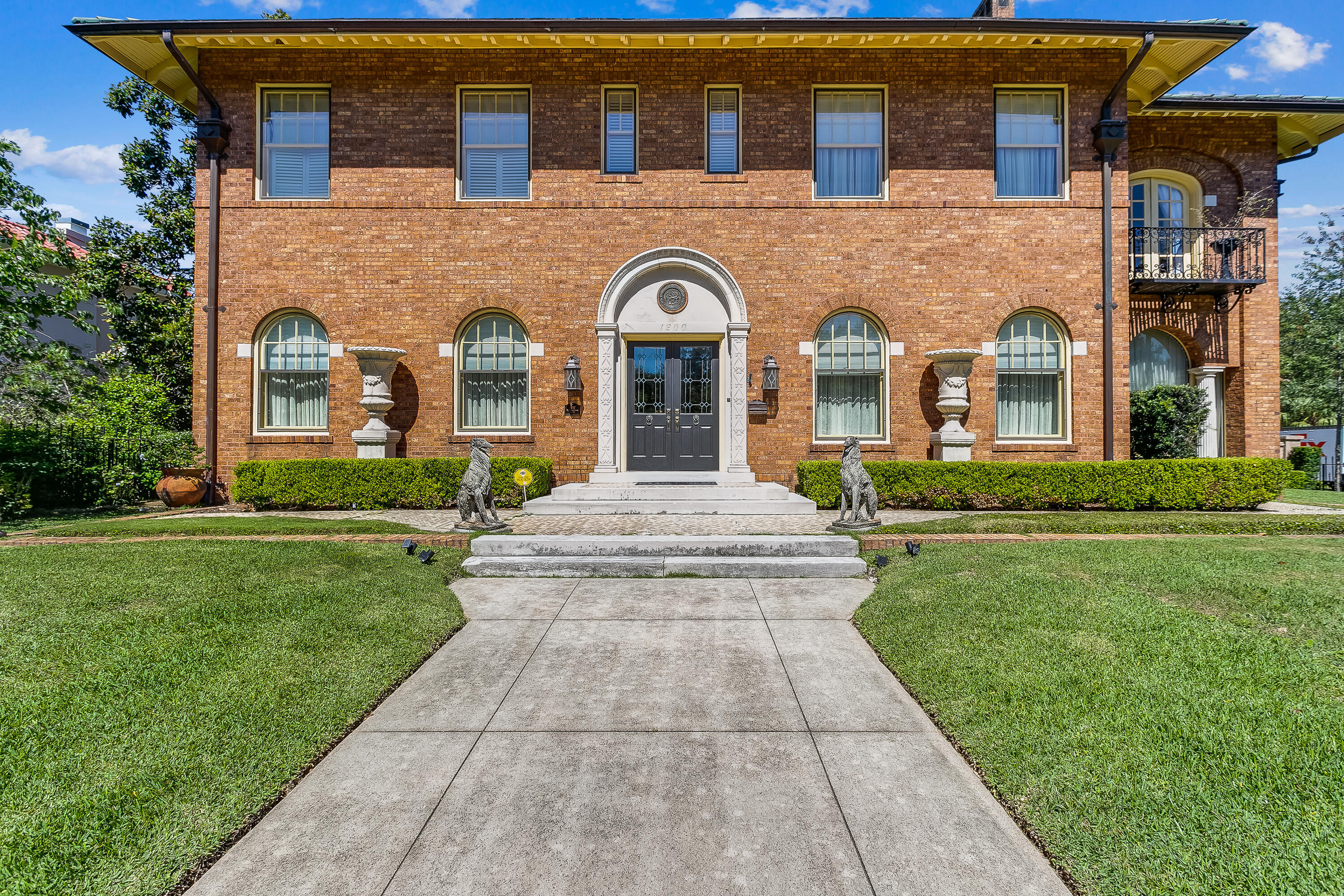 . Perched atop one of the highest points in Pensacola, this elevated luxury property takes premier ownership in North Hills to another level. This truly remarkable luxury retreat has it all.  Built in 1928 for Morris Bear, the impeccable details of the era are evident in this architecture masterpiece. This brick home with its Mediterranean flare has incredible curb appeal. Professionally landscaped and fully encapsulated by wrought iron fencing along with a stucco block wall rewards the owners with privacy and security. There is an automatic gate in the rear for your vehicles. 3 Bedrooms in the main home and the separate 3 car garage has a two story mother-in-law suite.
