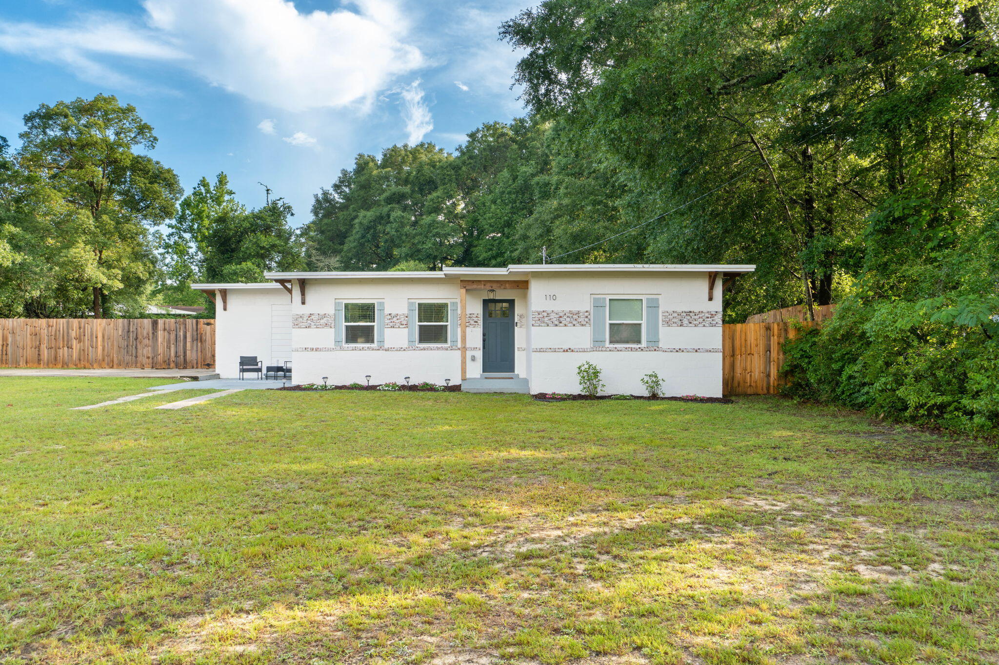 Welcome to 110 Butler Circle in Crestview, FL. This enchanting residence is a captivating blend of modern elegance and timeless charm. The manicured landscaping and inviting front porch create a warm and inviting atmosphere, setting the tone for the beauty that awaits.This spacious concrete block cottage was beautifully renovated in 2021 down to the tiniest of details. This home was completely gutted and built back new with numerous upgrades and extras. Starting with the exterior, there is a 2021 Roof, HVAC, and HWH. In addition, you can rest easy knowing the home has been completely re-wired with copper including service panels, outlets, switches, and fixtures. The house has also been replumbed in 2021 as well.