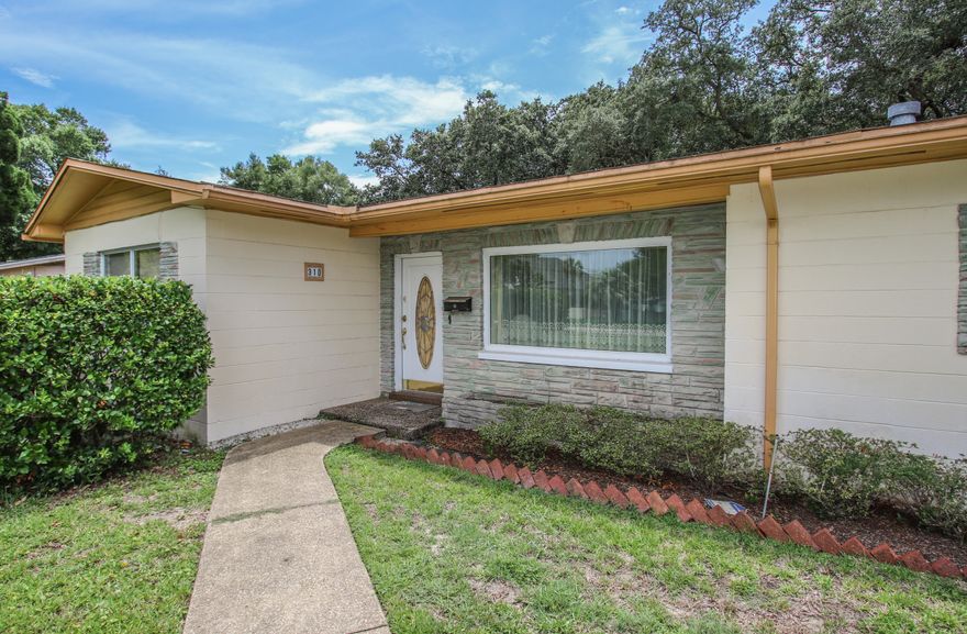 Sitting proud on a beautiful lot with stunning live oaks in the back yard, this 50's block cottage has a remarkably modern floor plan. All the square footage is there and then some for a handsome master retreat. A light-filled sitting room graces the entrance of a huge master bedroom with access to the private courtyard. The roomy master bath leads to a large walk-in closet. The size of this master space has most new construction beat! The second bedroom has both North and East facing windows and the guest bathroom has a walk-in shower and skylight. Light pours into the main living room...the cozy den with fireplace accesses another private patio. Loads of storage options in the 2 car garage round out the modern qualities of this classic cottage right across the street from the Bay.