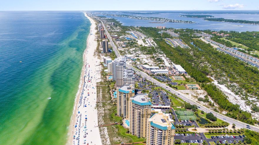 Opportunity awaits to own a lovingly maintained & beautifully furnished, never-rented residence in Perdido Key's premier gated, beachfront resort community of Indigo - A great investment or getaway! This Gulf front condo welcomes you with a private elevator entry foyer, leading into a spacious 2-bedroom, 2.5-bath layout. Step inside & onto the tile floors that will lead you through the living areas & primary bedroom. Enjoy breathtaking Gulf views from the master suite, which has a large, picturesque window, an expansive closet & direct access to the Gulf-facing balcony. The ensuite bathroom offers a large, tiled shower. The guest suite acts as a second primary suite, offering the perfect spot to relax on the suite's private north-facing terrace, offering stunning vistas of the