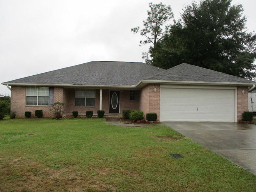 Don't miss the opportunity to pick up this HUD REO home, just mins for I10 Access and a short drive from Pensacola, Gulf Breeze, Navarre, and more. This 1838sf home was built in 2004 and comes with split bedroom 4 bedrooms and 2 baths. All brick exterior with 2 car garage. Home is located in the Woodbury Forest Subdivision and with a little TLC will shine bright. Home needs mostly cosmetics and is a must see to appreciate. Call today! FHA Insurable with Escrows (IE) $1800.