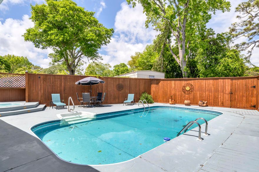 Private Pool home bursting with curb appeal! Well maintained home features 31 x 41' pool patio surrounding a sparkling pool and a 13' x 15' hot-tub deck.  Relax in the heated/cooled sunroom overlooking the pool. Enter the front foyer to find a large 17' x 16' eat-in kitchen and quartz counters with a center island and stainless refrigerator, sink and dishwasher.  Plenty of room for a table or dine at the breakfast bar.  Large windows bathe the home in natural sunshine. Custom white built-ins flank one wall and TV conveys.  Tile and laminate flooring throughout for ease of maintenance.  En-suite Master bath features a large walk-in shower, built-in seats and skylights.  Kitchen opens to the living room to enhance open-concept living.  Roof and pool liner each 3 years old.