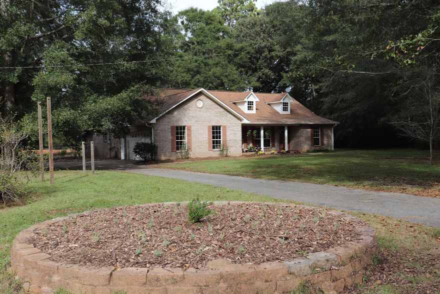 Charming home on 10 acres with home nestled among trees. Room for pets and and larger animals. A couple small buildings can stay for your animals. This is a serene area where the home is tucked back off the road and the owners and pets are not bothered by cars or people - however, they say the neighbors are nice.Owners have improved the home with ne flooring throughout - tile and wood look flooring and painted the walls!They have a redone the pond area for ducks and some new fencing.