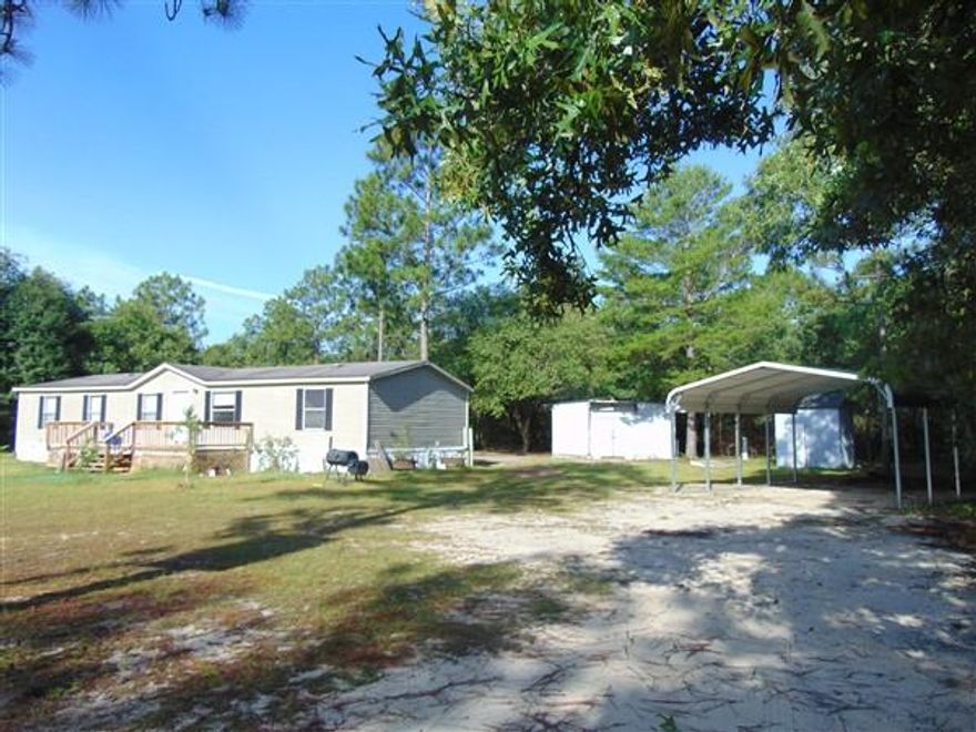 Great location for this 2001 4 BR, 2 bath Pioneer manufactured home on apx. 10 acres (9.64 per property appraiser). Located on paved road and conveniently located less than 3 miles to I-10 & Hwy 285 for quick access to Defuniak Springs, Crestview, Eglin AFB, Ft Walton Beach & Niceville. There is a gate at entry to property and home sits back nicely from the road. Several fruit trees (grapefruit, orange, nectarine, peach), in addition to garden area. Exterior features include detached metal carport, 20x20 workshop with concrete floor, well house, 8x24 front deck, 8x16 back deck. Interior features include living and family room (fireplace in family); Double vanities, garden tub and separate shower in master bath. Be sure to put this one on your list to see!
