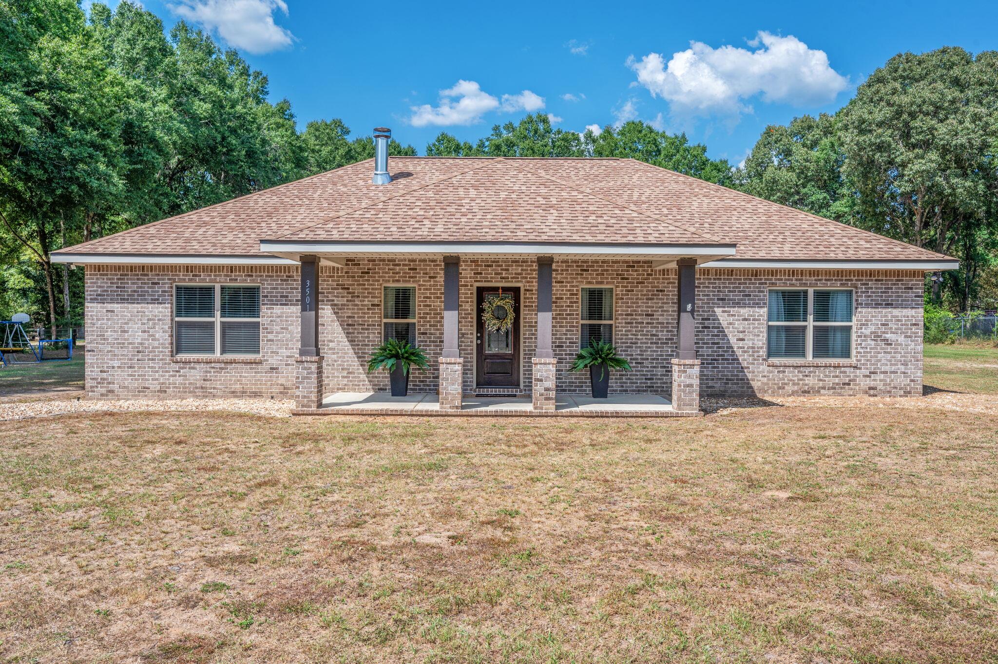 Built in 2020, this stunning custom home offers the perfect blend of modern upgrades and timeless charm. Featuring 3 spacious bedrooms and 2 full baths, every detail has been thoughtfully designed. From the upgraded cabinetry & beautiful granite countertops throughout, to the cozy all brick fireplace and custom tile shower in the primary suite. Enjoy quiet mornings on the charming front porch or relax and entertain on the large back porch overlooking your 1+ acre tree-lined lot.Car enthusiasts, hobbyists, or anyone needing extra space will love the impressive 40x48 workshop on a concrete slab, two oversized roll-up doors, with water & electricity in place. Ready for all your projects and storage needs! Experience the lifestyle this home offers! Book your tour before it's gone.