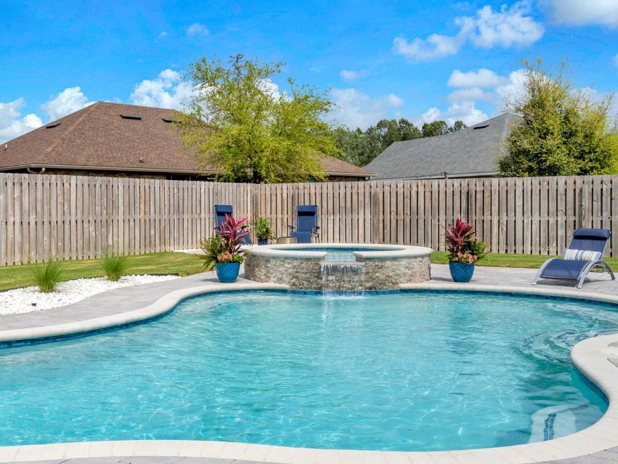 Premium Living in an Idyllic Community:Imagine year-round resort-style living in this exceptional home nestled on a serene cul-de-sac. Slip into your heated saltwater inground pool and spa with a soothing waterfall feature, then relax and entertain outdoors across the expansive paver patio or within the inviting screened lanai, all surrounded by a fully fenced and immaculately manicured yard. Over $6,000 in premium landscaping beautifully elevates the exterior and creates an inviting approach. Car enthusiasts will revel in the attached 3-car, climate-controlled garage complete with Trax flooring and a shop sink, plus extra parking outside. Enjoy uninterrupted comfort with a whole-house generator.Inside, discover sophisticated details at every turn: soaring 12' ceilings, elegant crown molding, striking arched doorways, and an artful display alcove in the entryway. The heart of this home is a beautifully appointed gourmet kitchen, featuring a gas stove, sleek stainless steel appliances, and the refined beauty of quartz countertops. Impeccably crafted quartz countertops can also be found in every bathroom. The luxurious primary suite offers a peaceful space with a trey ceiling and a spa-inspired bathroom designed with a soaking tub, private water closet, dual sink vanity, and dual closets. A convenient Jack and Jill bathroom with a dual sink vanity serves the second and third bedrooms. Enjoy peace of mind with practical features including gutters, rainbird irrigation, a gas water heater, and a termite bond. This is more than a home; it's an elevated way of life.

Discover the captivating lifestyle of Hammock Bay! Embrace coastal living with direct Bay access, a stunning Bayfront clubhouse, and a convenient kayak launch. Enjoy premium amenities including multiple resort-style pools, a playground, well-appointed fitness center, pickleball, tennis, and basketball courts. Explore scenic nature trails and miles of bike/walking paths. The vibrant Town Center is the perfect place to connect! Enjoy concerts and markets on the green by the pavilion, catch live music at the brewery, savor a gourmet coffee at Abide, and browse the charming general store. It's where community comes together! With multiple marinas and boat launches nearby, and just 17 miles from the breathtaking beaches of Santa Rosa Beach, Hammock Bay offers the perfect blend of nature, recreation, and community connection. Your new life awaits! Reach out today to schedule your private tour. 