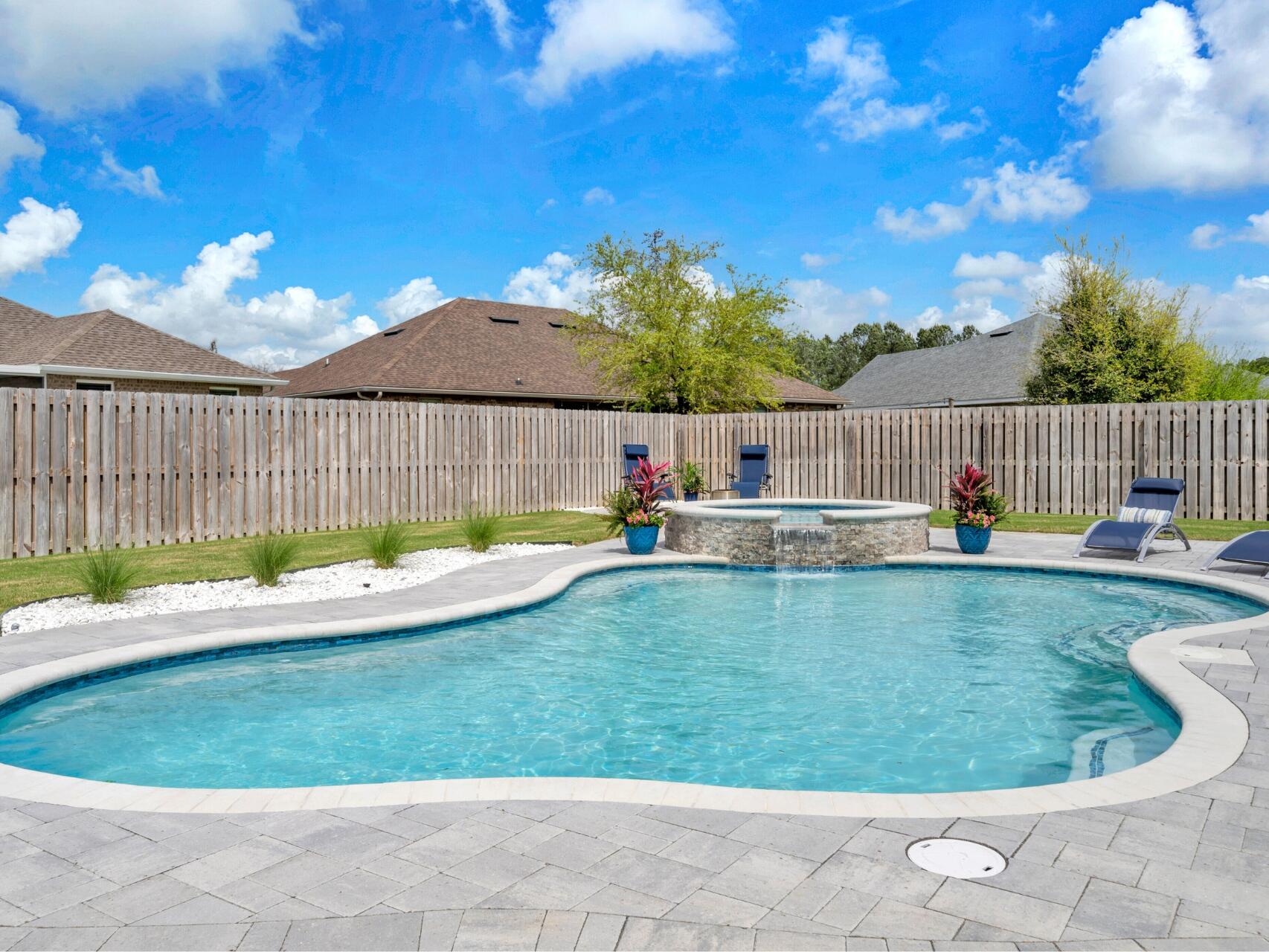 Premium Living in an Idyllic Community:Imagine year-round resort-style living in this exceptional home nestled on a serene cul-de-sac. Slip into your heated saltwater inground pool and spa with a soothing waterfall feature, then relax and entertain outdoors across the expansive paver patio or within the inviting screened lanai, all surrounded by a fully fenced and immaculately manicured yard. Over $6,000 in premium landscaping beautifully elevates the exterior and creates an inviting approach. Car enthusiasts will revel in the attached 3-car, climate-controlled garage complete with Trax flooring and a shop sink, plus extra parking outside. Enjoy uninterrupted comfort with a whole-house generator.Inside, discover sophisticated details at every turn: soaring 12' ceilings, elegant crown molding, striking arched doorways, and an artful display alcove in the entryway. The heart of this home is a beautifully appointed gourmet kitchen, featuring a gas stove, sleek stainless steel appliances, and the refined beauty of quartz countertops. Impeccably crafted quartz countertops can also be found in every bathroom. The luxurious primary suite offers a peaceful space with a trey ceiling and a spa-inspired bathroom designed with a soaking tub, private water closet, dual sink vanity, and dual closets. A convenient Jack and Jill bathroom with a dual sink vanity serves the second and third bedrooms. Enjoy peace of mind with practical features including gutters, rainbird irrigation, a gas water heater, and a termite bond. This is more than a home; it's an elevated way of life.
Discover the captivating lifestyle of Hammock Bay! Embrace coastal living with direct Bay access, a stunning Bayfront clubhouse, and a convenient kayak launch. Enjoy premium amenities including multiple resort-style pools, a playground, well-appointed fitness center, pickleball, tennis, and basketball courts. Explore scenic nature trails and miles of bike/walking paths. The vibrant Town Center is the perfect place to connect! Enjoy concerts and markets on the green by the pavilion, catch live music at the brewery, savor a gourmet coffee at Abide, and browse the charming general store. It's where community comes together! With multiple marinas and boat launches nearby, and just 17 miles from the breathtaking beaches of Santa Rosa Beach, Hammock Bay offers the perfect blend of nature, recreation, and community connection. Your new life awaits! Reach out today to schedule your private tour.