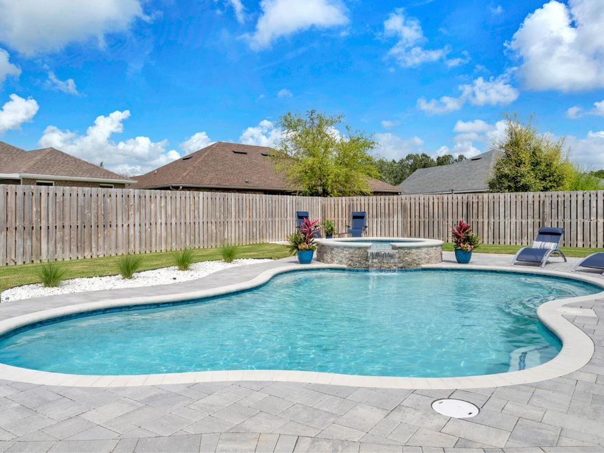 Premium Living in an Idyllic Community:Imagine year-round resort-style living in this exceptional home nestled on a serene cul-de-sac. Slip into your heated saltwater inground pool and spa with a soothing waterfall feature, then relax and entertain outdoors across the expansive paver patio or within the inviting screened lanai, all surrounded by a fully fenced and immaculately manicured yard. Over $6,000 in premium landscaping beautifully elevates the exterior and creates an inviting approach. Car enthusiasts will revel in the attached 3-car, climate-controlled garage complete with Trax flooring and a shop sink, plus extra parking outside. Enjoy uninterrupted comfort with a whole-house generator.Inside, discover sophisticated details at every turn: soaring 12' ceilings, elegant crown molding, striking arched doorways, and an artful display alcove in the entryway. The heart of this home is a beautifully appointed gourmet kitchen, featuring a gas stove, sleek stainless steel appliances, and the refined beauty of quartz countertops. Impeccably crafted quartz countertops can also be found in every bathroom. The luxurious primary suite offers a peaceful space with a trey ceiling and a spa-inspired bathroom designed with a soaking tub, private water closet, dual sink vanity, and dual closets. A convenient Jack and Jill bathroom with a dual sink vanity serves the second and third bedrooms. Enjoy peace of mind with practical features including gutters, rainbird irrigation, a gas water heater, and a termite bond. This is more than a home; it's an elevated way of life.

Discover the captivating lifestyle of Hammock Bay! Embrace coastal living with direct Bay access, a stunning Bayfront clubhouse, and a convenient kayak launch. Enjoy premium amenities including multiple resort-style pools, a playground, well-appointed fitness center, pickleball, tennis, and basketball courts. Explore scenic nature trails and miles of bike/walking paths. The vibrant Town Center is the perfect place to connect! Enjoy concerts and markets on the green by the pavilion, catch live music at the brewery, savor a gourmet coffee at Abide, and browse the charming general store. It's where community comes together! With multiple marinas and boat launches nearby, and just 17 miles from the breathtaking beaches of Santa Rosa Beach, Hammock Bay offers the perfect blend of nature, recreation, and community connection. Your new life awaits! Reach out today to schedule your private tour. 