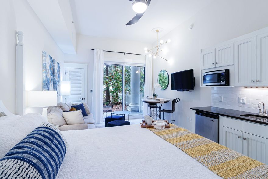 FRIST FLOOR STUDIO with white picket fence in back yard- charming, beautifully updated furnished studio has it all! Ideally situated on the first floor, this light-filled condo is rental-ready with a fresh new look, stylish furnishings, and soaring 10-foot ceilings. Just steps from the heart of Baytowne Wharf, you'll enjoy easy access to dining, shopping, live music, and year-round events. With a king bed and queen sleeper sofa, it comfortably hosts a couple, small family, or group of friends. The tennis center is nearby, and beach access is just a quick ride away via car or Sandestin's shuttle. With a strong rental history and priced to sell, this is a rare opportunity to own a piece of the resort lifestyle. Financing options available with lenders. Air conditioner 2023
New furniture, decor, bed, bedding, mattress 2022, pillows, 
lighting, drapes, microwave, coffee pot, toaster, silverware, plates, glasses, bathroom vanity, bath, shower and sink faucets, refreshed tile. outdoor furniture and refreshed outdoor space. 

Sandestin Golf and Beach Resort features more than seven miles of beaches and pristine bay front, four championship golf courses, 15 world-class tennis courts, a 226-slip marina, a fitness center, spa and celebrity chef dining. Shop, dine and play at the charming pedestrian village, The Village of Baytowne Wharf and more. Inside the gates of the resort, residents enjoy a balanced lifestyle of high-class living, spanning the 2,400 acres from the beach to the bay. Everything within the gates of the resort is accessible by golf cart or bicycle. The entire resort is interconnected by miles of pedestrian, bike and golf cart paths that weave through groves of live oaks, meandering past natural lagoons, fountains, man-made lakes, and meticulously landscaped fairways.
