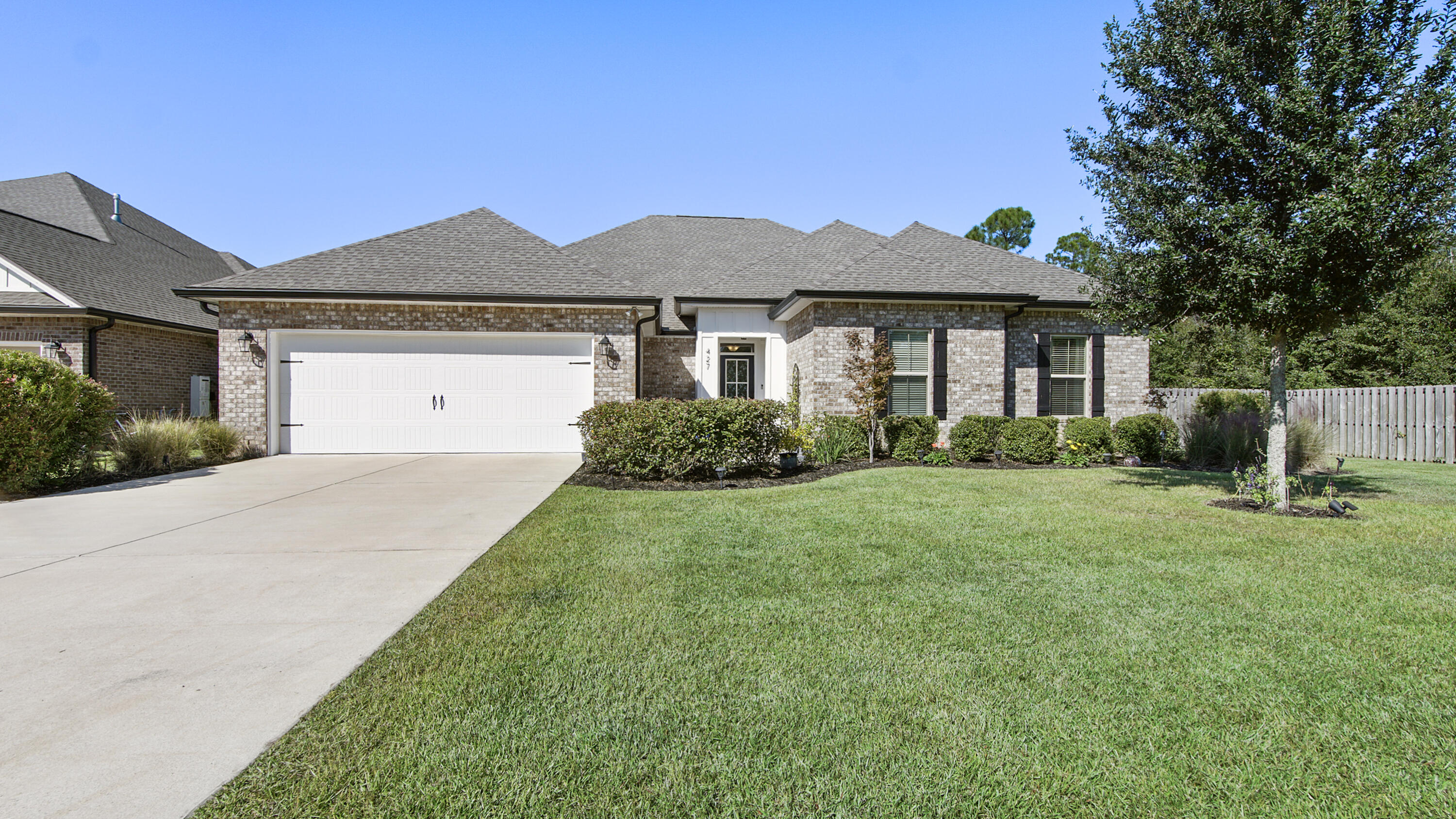Welcome to 427 Blaze Blvd in The Trails of Hammock Bay, DSLD's sought-after,''Christopher'' w 5 beds, 3 full bath 2-story, 3374 sq' of living- PLENTY of room for everyone!!! Wood-like tile floor throughout main living area and plush upgraded carpet in all bedrooms and Bonus Room. 10' ceilings in Foyer, Kitchen And Dining Room. Open concept Great Room/Kitchen-white shaker style cabinets, Frigidaire appliances (Refrigerator is incl), quartz counters with so much storage and counter space! Black hardware accents. Great Room w BOLD NAVY accent wall and gas fireplace. A GREAT LAYOUT!!! $30K upgrade in Mud Room and Laundry Room-custom cabinetry (reaches to ceiling for extra storage), custom blk walnut folding counter in laundry and fold out hanging bar. Touch screen ADT security system stays w house. Gorgeous designer wall paper in laundry and mud room which coordinates with custom painted cabinets. Washer/dryer convey! Ready to do laundry on day one- in a beautiful space!!! 2 car garage w custom ''Slat Wall'' for all the beach chairs, beach/pool gear. First floor master on one side of house w oversized Main Bath- soaker tub, walk-in shower, LARGE closet which connects to the Laundry Room, added BONUS! Double sinks w quartz counters, Black framed mirrors and tiled floor. 3 additional bedrooms on opposite side of house on first floor w additional bathroom. And an extra ''flex/workspace''- great for school work or a work-from-home office. The 2nd floor has a BONUS/FAMILY ROOM w another bedroom and full bath. Great for MOVIE NIGHTS!!! The LOT-is an oversized end lot w woods on one side, 6' privacy fence surrounds backyard and a 24'x12' brick paver patio to enjoy the beautiful outdoors. INCREDIBLE AMENITIES of Hammock Bay- 3 Pools, Clubhouse, Fitness Ctr, Bball, tennis and pickleball courts, General Store, Props Brewery FUN FOR ALL!!!