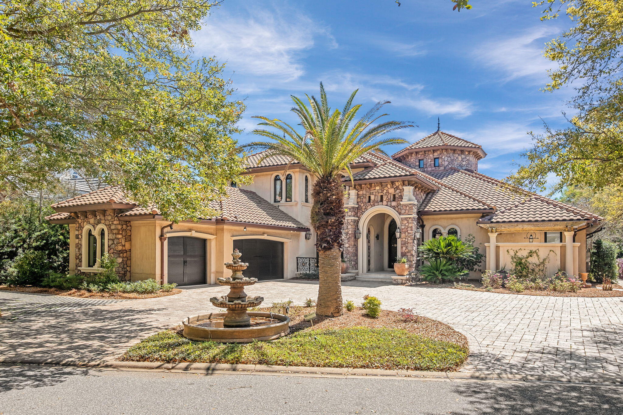 Built with the highest quality Insulated Concrete Form (ICF) construction, 437 Admiral Court is a palatial estate located on a quiet lake in Regatta Bay, Destin's premier gated golf course community. This custom-built home boasts some of the highest quality finishes that can be found on the Emerald Coast; the exterior is adorned with pecky cypress corbels, ipe decking, a commercial-grade space heater, outdoor chef's kitchen, screened-in lanai, and an Italiantumbled paver driveway. The impeccable quality of materials extends to the interior of the homewhich is highlighted by custom mahogany kitchen cabinetry, a stunning mahogany-panelledhome office, imported Calcutta marble flooring, a Eurowall that connects the indoor and outdoorliving areas, walk-in butler's pantry temperature controlled wine storage, and a THX-certified
home cinema with seating for eight along with a separate kitchen. The home also has a geothermal heating & cooling system and high-end appliances such as a 63" SubZero refrigerator, 48" Wolf Range, & a commercial grade steam room in the primary suite.
The curb appeal of 437 Admiral Court is unmatched with carefully curated landscaping, gorgeous imported Italian tumbled stone paver driveway, three-car garage, a 15' grand archway framed with gas lanterns, and pecky cypress corbels adorning the garage and street-facing exterior walls.
Upon entering the home, you're greeted with Calcutta marble flooring, and a tranquil indoor water feature that's framed by a 15' barreled ceiling. The fresco-painted dining area exudes
refined elegance and coastal charm, while the 30' ceiling in the grand sitting room is reminiscent of the nobility and refinement of the Renaissance era.The entire home is wired with fiber optic
cable and smart home technology, so it combines old world beauty with modern technology and convenience. Past the dining room is the built-in mahogany bar complete with a glass-encased
& temperature controlled wine room that's perfect for displaying rare vintages. The bar seamlessly connects to the kitchen via a cross vaulted ceiling. The kitchen boasts custom mahogany cabinets, Wolf & SubZero appliances, and a walk-in butler's pantry all framed by
striking Siena marble countertops. The kitchen & living room combine to create an ideal space for entertaining, and the Eurowall that adjoins the living room and outdoor area makes it an
even more dynamic space.
When your guests step outside the Eurowall they'll be greeted by stunning Ipe flooring, a fully equipped outdoor kitchen, outdoor gas fireplace, and a 20'x15' heated pool complete with waterfall features. The outdoor seating area also features a commercial grade heater so that the space can be utilized year-round.
The first floor has an ideal bedroom layout for privacy; the master wing occupies the majority of the right side of the home and there's a separate full guest suite off the garage on the opposite
side of the house. This guest suite essentially functions like an attached carriage house because it has its own side door entrance, and it's also directly adjacent to both the garage and
the sizable walk-in laundry room. The master suite is a masterclass in luxury complete with a private wet bar, heated marble
flooring in the bathroom, a commercial grade steam room, two separate full-sized vanities, walk-through shower, and a zero-edge jacuzzi spa. The master suite also has a private fireplacethat frames a sitting area with views of the pool and the lake. The two walk-in closets are accented with custom built-in cabinetry and a sizable Carrara marble & mahogany island.
The grand staircase serves as a focal point in the home & crescendos with a Juliette balcony that's positioned to enjoy views of the custom-painted medallion ceiling that's inlaid with twinkling fiber-optic lighting. The home is equipped with an elevator as well. The second level guest suites each have their own full baths attached as well as walk-in closets. The THX-certified home cinema system is outfitted with the highest quality sound and visual systems. It also has an attached full bathroom, guest suite, and its own kitchen.
437 Admiral Court truly has some of the highest quality construction materials and finishes of any home on the Emerald Coast. No expense was spared and every detail is a marvel. Schedule your private tour of this 2010 Parade of Homes award winning masterpiece today.