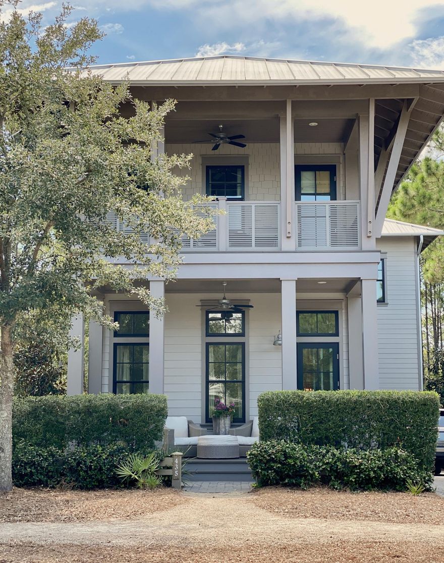 Beautiful home that is professionally decorated 4 bedroom and 4.1 baths that are all finished in marble. It features soaring 12' ceilings, distressed oak floors, abundant shiplap and lots of windows with great light. The gourmet kitchen features Thermador appliances and a large Carrera marble island perfect for entertaining.  The kitchen opens to the dining and living areas that flows onto a deep covered porch that overlooks the wooded conservation area in the rear with steps down to a paver patio with summer kitchen. The home also features a private additional living area that can be used as an office or den.  One of four ensuite bedrooms is conveniently located on the 1st floor. Two window-lined luxurious Masters have beautiful baths with private covered porches that have wonderful views
