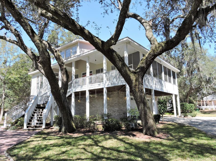 Beautiful Southern Living house plan with Bayou views, built 2004. Imagine sitting on your front porch in your rocking chairs enjoying peaceful bayou breezes. You can walk right across the street to the marina & fantastic restaurant. Entertainers dream house - kitchen is well equipped w/stainless steel 5 burner gas stove, SS appliances, granite counters, beautiful cabinetry, hardwood flooring, & high ceilings. Great room w/hardwood flooring, bayou views, salt water fish tank, gas fireplace, & double doors to a wrap around screen porch w/more entertaining space. Spacious Master suite w/large bedroom, bathroom w/double vanities, double walk-in closets, tub, and walk in shower. There is another bedroom, full bath, laundry on main floor. Ground floor has guest suite w/bath, 3car garage...