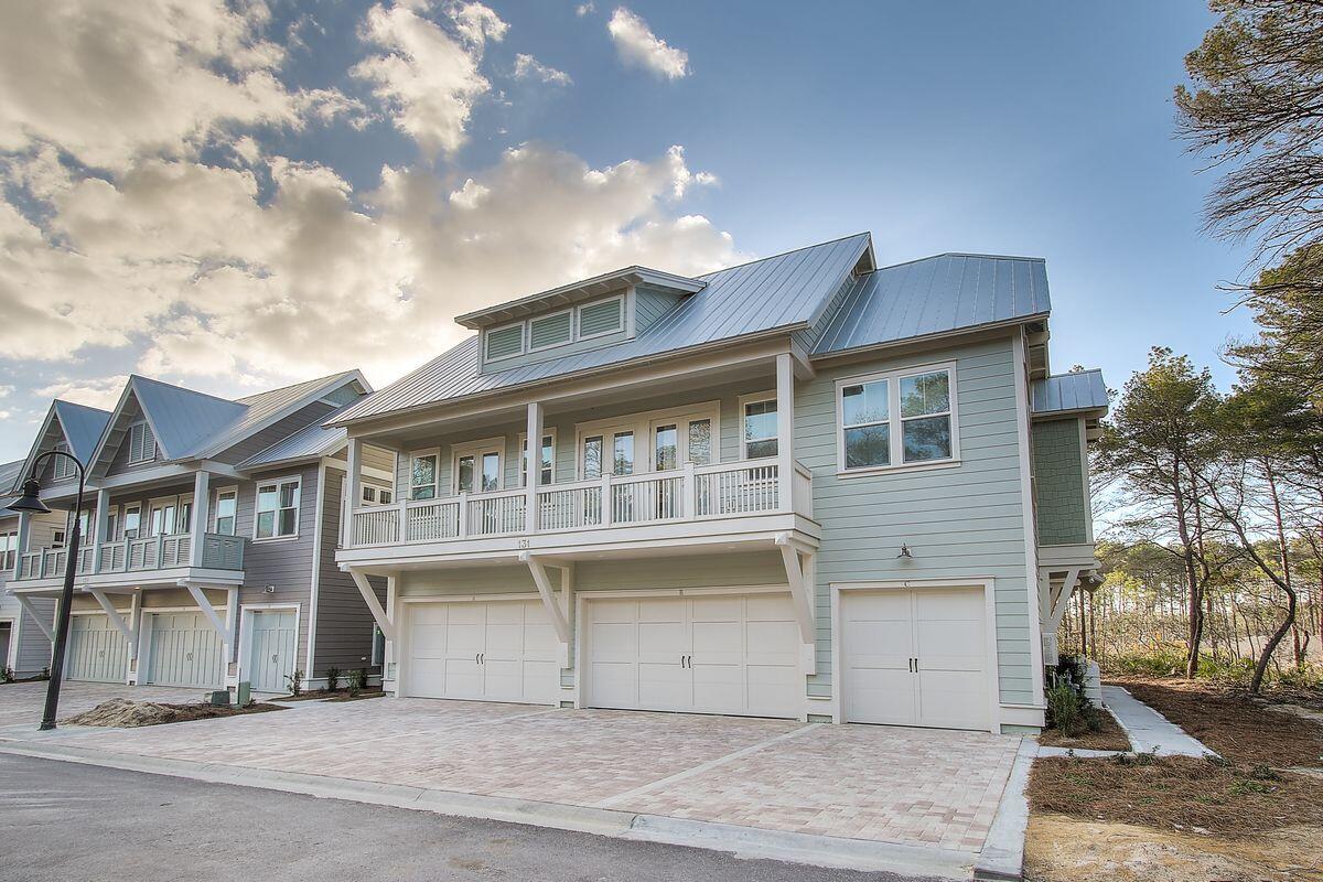 Positioned in the absolute best and most private location in Prominence, this three-bedroom townhome sits on the only cul-de-sac in the community, surrounded on three sides by the community forest and Deer Lake State Park. The open concept floor plan provides a spacious and comfortable layout for both relaxation and vacation excitement crafting an ideal opportunity as either a second home or an investment property. You will feel like you have arrived at a resort the moment you step into this light and airy beach home. The open living and dining areas have 10-ft. ceilings and plenty of windows for a bright and spacious feel. Durable and modern wood look tile flows throughout the home, including the upstairs bedrooms and bathrooms, making it ideal for high traffic. The color palette is bright and neutral, with ivory white cabinets, shiplap and plantation shutters throughout, and a glass subway backsplash. Thick stone granite countertops and vibrant stainless appliances fill the contemporary kitchen with touches of coastal luxury. Shiplap accents and stained oak treads lead you up the staircase to the second floor where the master suite resides. Fit with a king bed, 12-ft. ceilings, floor-to-ceiling windows, and a beautiful en suite bath, this room gives you a sense of luxury. The second bedroom also houses a king bed while the third bedroom is stocked with custom built-in bunks where the kids will feel like they have their own beachy clubhouse. The ground floor includes a full-sized laundry room and access to the spacious garage. Storage is plentiful with two large owner's closets and a huge "gear closet" within the garage, which was custom built to store e-bikes, paddleboards, a bbq grill, and all of your beach gear.

Situated between Rosemary Beach and Seaside, Florida, Prominence is a hip and desirable location for enjoying the 30A lifestyle. Resort amenities include an oversized 5,000-sq.-ft. community pool and well-outfitted fitness center, as well as direct access to The Big Chill (formerly The Hub), only footsteps away. Enjoy live music, excellent shopping and delicious dining year-round at the market-inspired 30A destination. In addition, there is an uninterrupted 17-mile bike path adjacent to 30A that cuts through the center of the community. This property is sold mostly furnished with only a few exclusions. The prime location of this townhome and its custom upgrades cannot be overemphasized - there is no other like it in the community.

