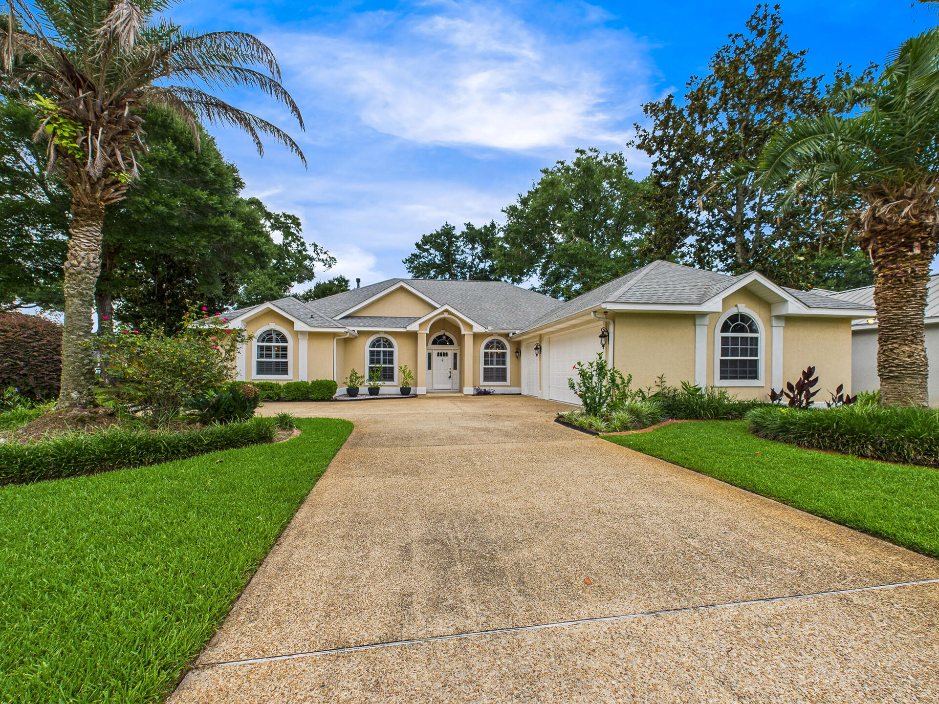 Situated on an oversized lot and a half, this beautifully updated and meticulously maintained 4 bedroom, 2 bathroom home offers a split floor plan, high ceilings, and an abundance of natural light throughout. From the moment you walk in, you'll notice the rich wood-look tile flooring, elegant crown molding, and plantation shutters. The spacious kitchen is a true focal point, featuring granite countertops, solid wood cabinetry, stainless steel appliances, and a breakfast bar that opens into a comfortable dining nook. The kitchen flows seamlessly into the large main living area, where you'll find vaulted ceilings, a gas fireplace, and two sets of quadruple sliding glass doors that open fully to a massive screened-in lanai. The primary suite is generously sized and privately located, complete with a trey ceiling, two walk-in closets, dual vanities, a soaking tub, and a separate shower. All secondary bedrooms are comfortably oversized, offering plenty of space for guests, kids, or a home office. Enjoy a peaceful backyard that backs up to protected green space which means no rear neighbors for added privacy. The oversized 3 car garage offers ample storage, and the extended driveway accommodates extra parking with ease. Additional upgrades include a new roof (2021), new HVAC system (2023), water heater (2021), and updated electrical panel. All the big-ticket items have already been handled for you. Enjoy the Florida lifestyle with access to Bluewater Bay's golf course, tennis center, marina, walking trails, and community pool just minutes away. This home combines quality construction, stylish updates, and a prime location making it a standout opportunity in one of Niceville's most desirable neighborhoods.