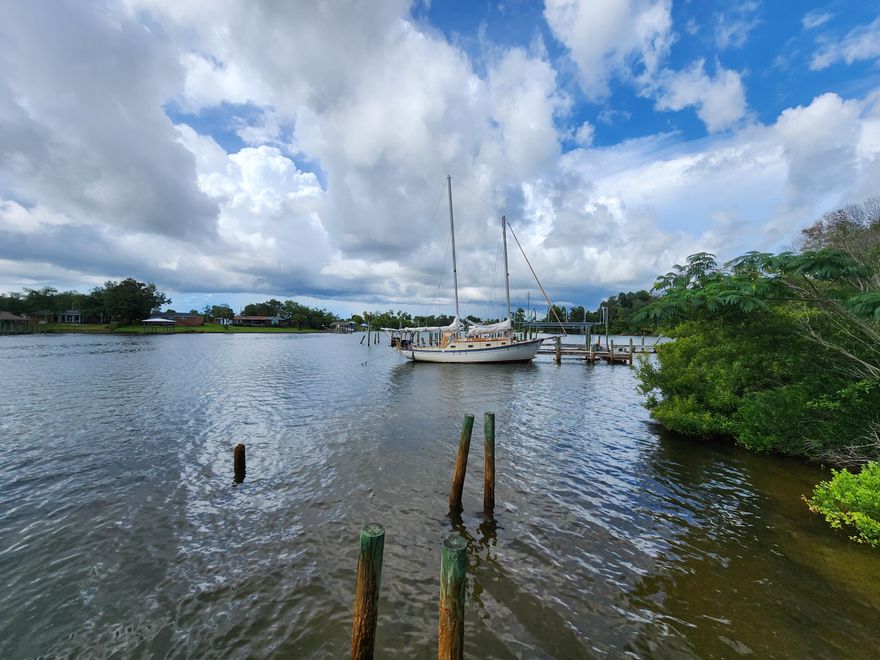 Rare diamond in the rough! Zoned MU-1. 94.9 ft of shoreline on Pitts Bayou w/deep water access to Gulf. Situated on .946 acres, the property features a DSF home w/2000+ sf. Kitchen & bathroom have been updated. Large inside laundry area w/small office. One car garage w/carport & storage shed. New roof installed 2019. Gas stove & dryer convey. 20x40 workshop built w/2x6's instead of standard 2x4's. Large pole barn includes power pole. The well is currently nonfunctional as it needs a new tank. City Parker provides water. Mobile home & Apt provide no value due to condition. Located across DuPont Bridge from Tyndall AFB, the area is expected to boom in next few years w/completion of construction & added squadrons to base.