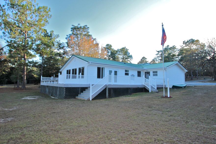 Come find the 3 R's on Spring Lake: relax, refresh, reset! Or add 2 more R's: retire and RV! This cottage beckons those who want to get away from it all. On serene Spring Lake, a private community, with a little over 1.5 acres, just 30 min from the beaches. Completely updated kitchen with white shaker cabinets, gleaming granite & panoramic views of the lake from the living room & wrap around deck, spanning the width of the house. You can even enjoy the view from your hot tub! You'll find a fully outfitted RV garage PLUS additional living quarters/garage that would be perfect for guests or mother in law suite - with to-die-for vaulted storage above! The owners are reluctantly selling their well-loved home due to health reasons. Will sell RV & Honda CRV separately for the ultimate pkg!
