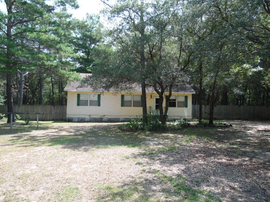 Really cute home on 1.2 acre lot just West of historical Defuniak Springs and East of Crestview. The home features a nice size eat-in kitchen, vaulted ceilings, utility room and a huge fenced back yard. The location is peaceful in a country setting but convenient to Old Hwy 90 for east commuting and employment opportunities! The enclosed front porch is heated and cooled so it is included in square footage. Listing agent has ownership interest. Huge price reduction! Property is being sold ''AS IS''