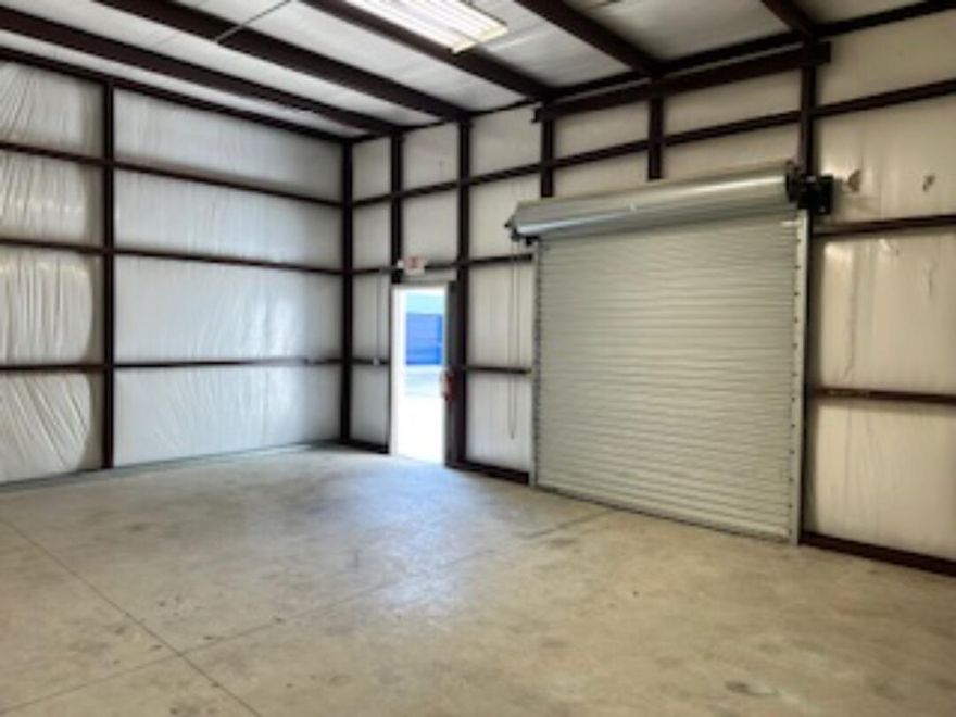 104-B 600 sq ft warehouse with 10'x 10' roll-up door, no restroom, and no AC.