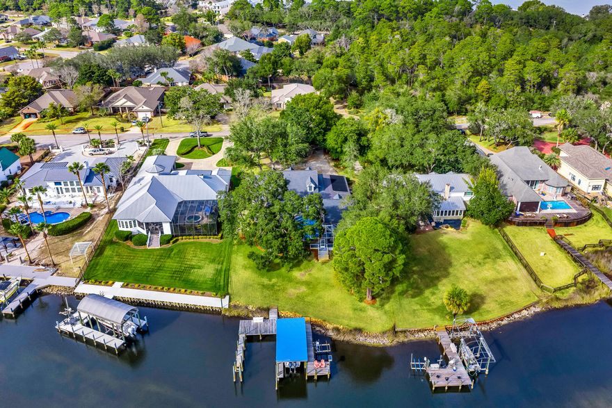 Situated on a picturesque bayou, this waterfront home offers a tranquil and peaceful lifestyle. Boasting a private dock, 2 boat slips, a boat and jet ski lift, it's perfect for boating enthusiasts with deep water access. A sprawling Southern wrap-around porch allows you to appreciate the stunning scenery, complete with majestic and mature oak trees. Enjoy the freedom of no HOA restrictions, and inside, you'll find three spacious bedrooms, tons of storage and a flexible workshop/hobby room. This residence blends the beauty of nature with comfortable, coastal living.
