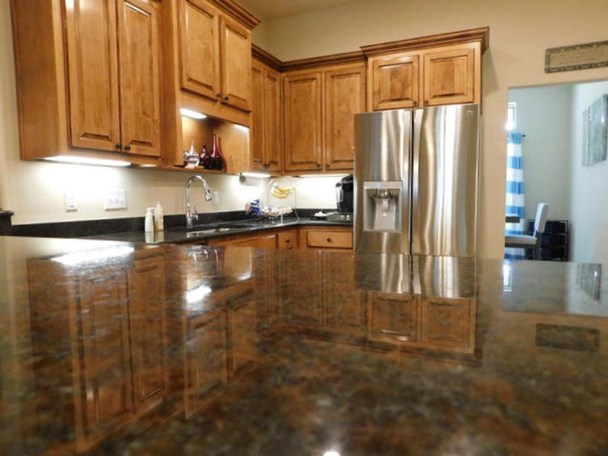 Large beautiful 2017 home and better than new with many upgrades. Inside you will find a large kitchen with Granite and high end stainless steel appliances, a large living room and even bigger great room overlooking the back yard and common wooded area. Ceilings are raised, textured, trayed and crowned. Bull nosed sheet rock corners , custom tiled master shower, split bedroom floor plan, formal dining room and a separate office at the foyer. Upgraded media wiring, security system, faux blinds& ceiling fans. Outside there is a large, covered deck that overlooks a common green space out back, seamless gutters, privacy wood fencing, an in ground sprinkler system, nice landscaping and the home is even covered with a termite bond in place. There are 4 bdrms, 2 liv rooms, office & formal dining!