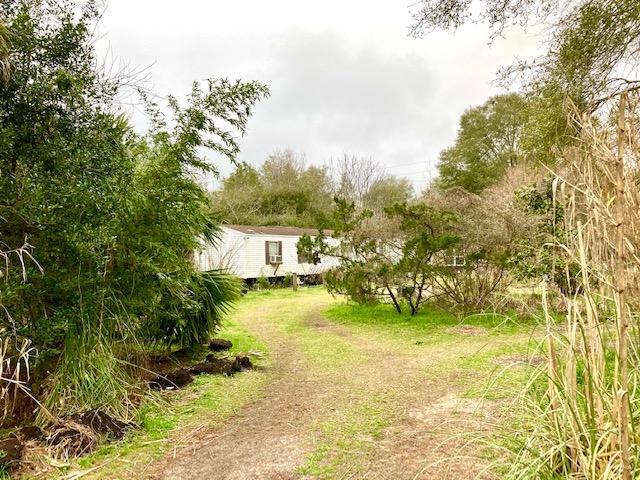 TWO LOTS ON HIGHWAY 90W, JUST 6 MILES WEST OF DEFUNIAK SPRINGS. There is a 2BR 2BA mobile home on the property that, due to some wood rot and structural issues is being given no value, although it may be able to be fixed up. The house has no central heat & air. There is a nice greenhouse with concrete floor on the property and several other sheds. There is also an unused well on the property. The mobile home is connected to Mossy Head Community Water, CHELCO Electric and has a working septic tank. There is an old survey of the property in the file. Both lots are enclosed by a high chain link fence. This property will by necessity need to be a cash deal. Seller is firm on price. All dimensions and square footage are approximate and subject to verification by owner at owner expense.